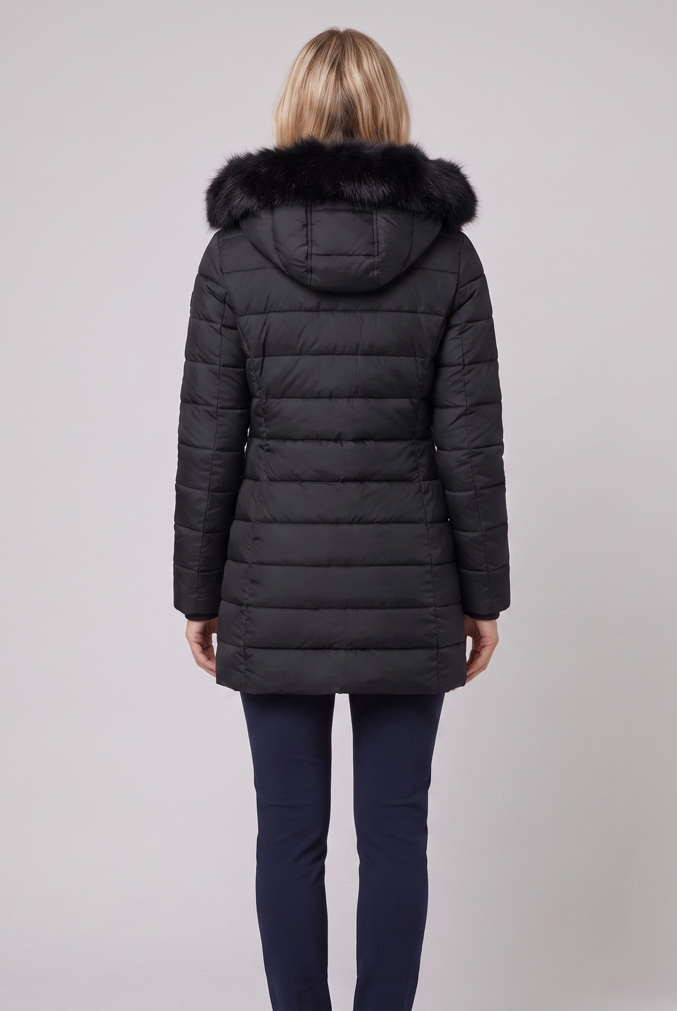 Evara lightweight hooded puffer jacket in black, back view on model