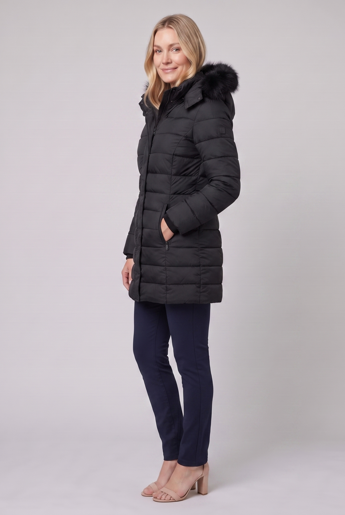 Evara lightweight hooded puffer jacket in black, side view on model