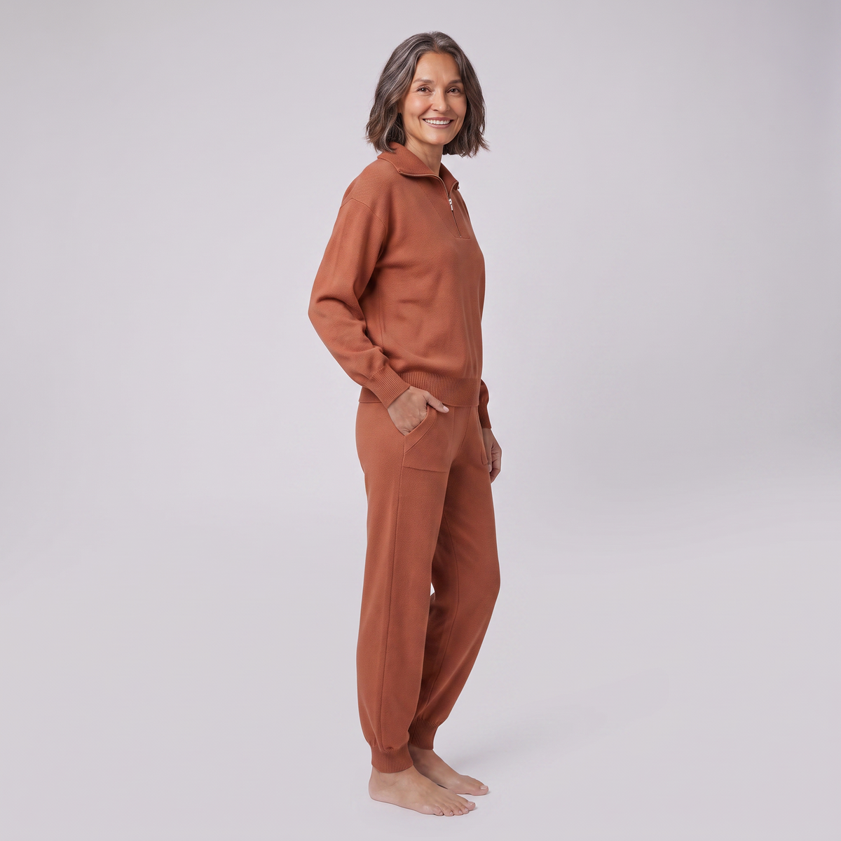 Fjorda half-zip knit lounge set in rust, side view on model