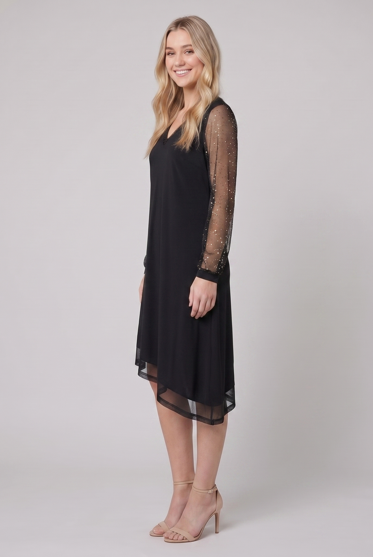 Genevieve sheer sleeve evening dress in black, side view on model