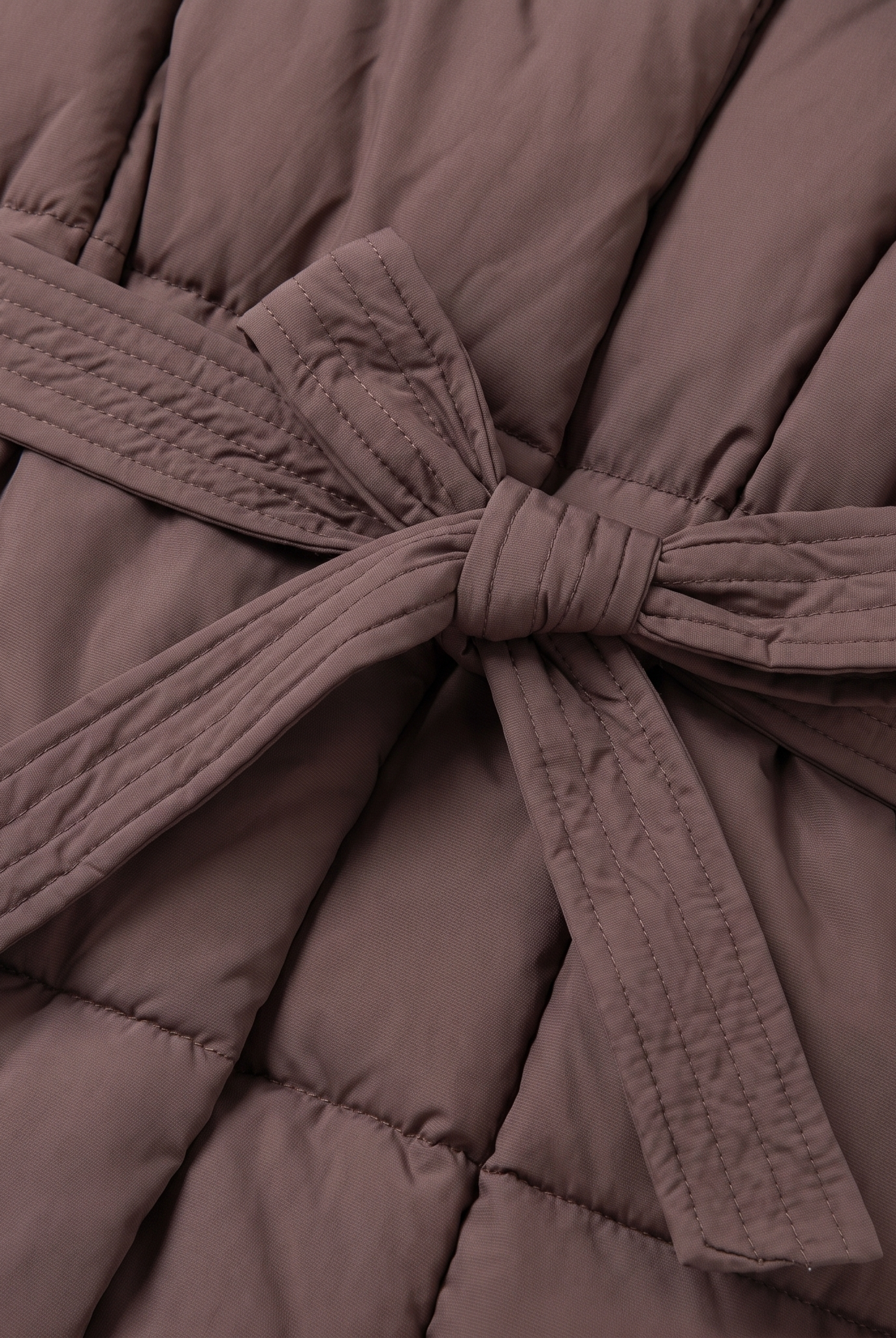 Haven puffer coat tied belt and quilting close-up