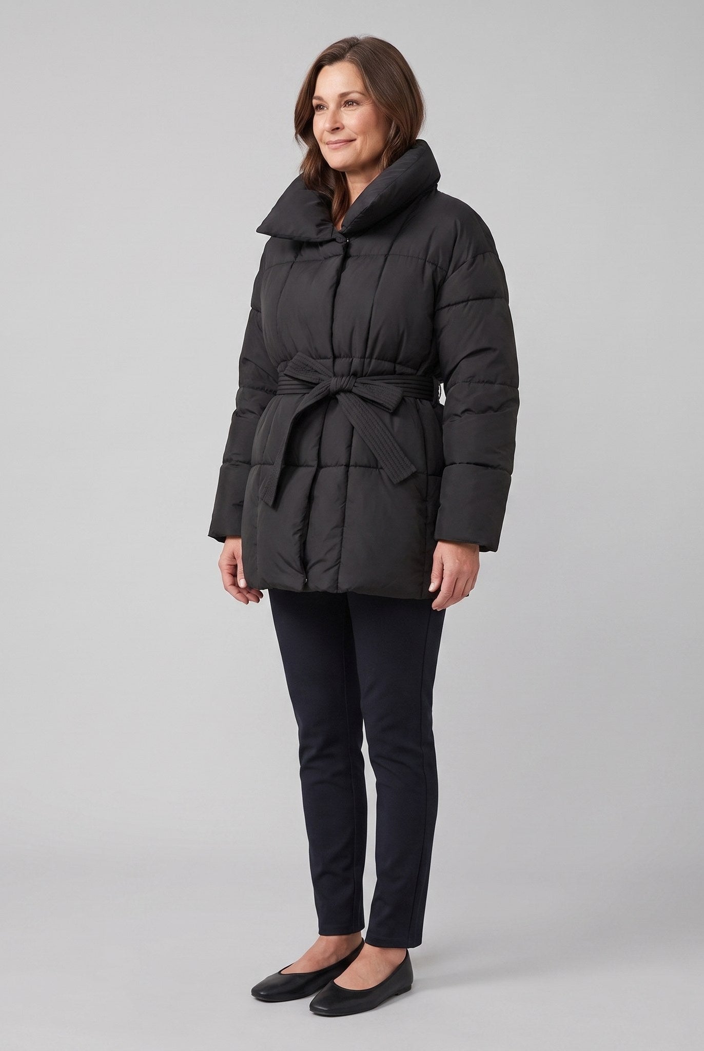 Haven belted puffer coat in black on model