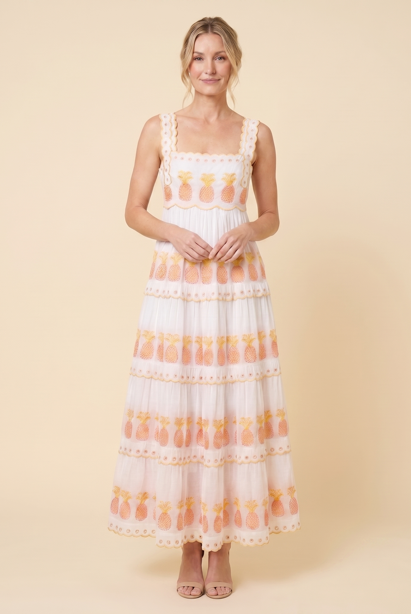 White pineapple-embroidered tiered maxi dress, relaxed pose on model