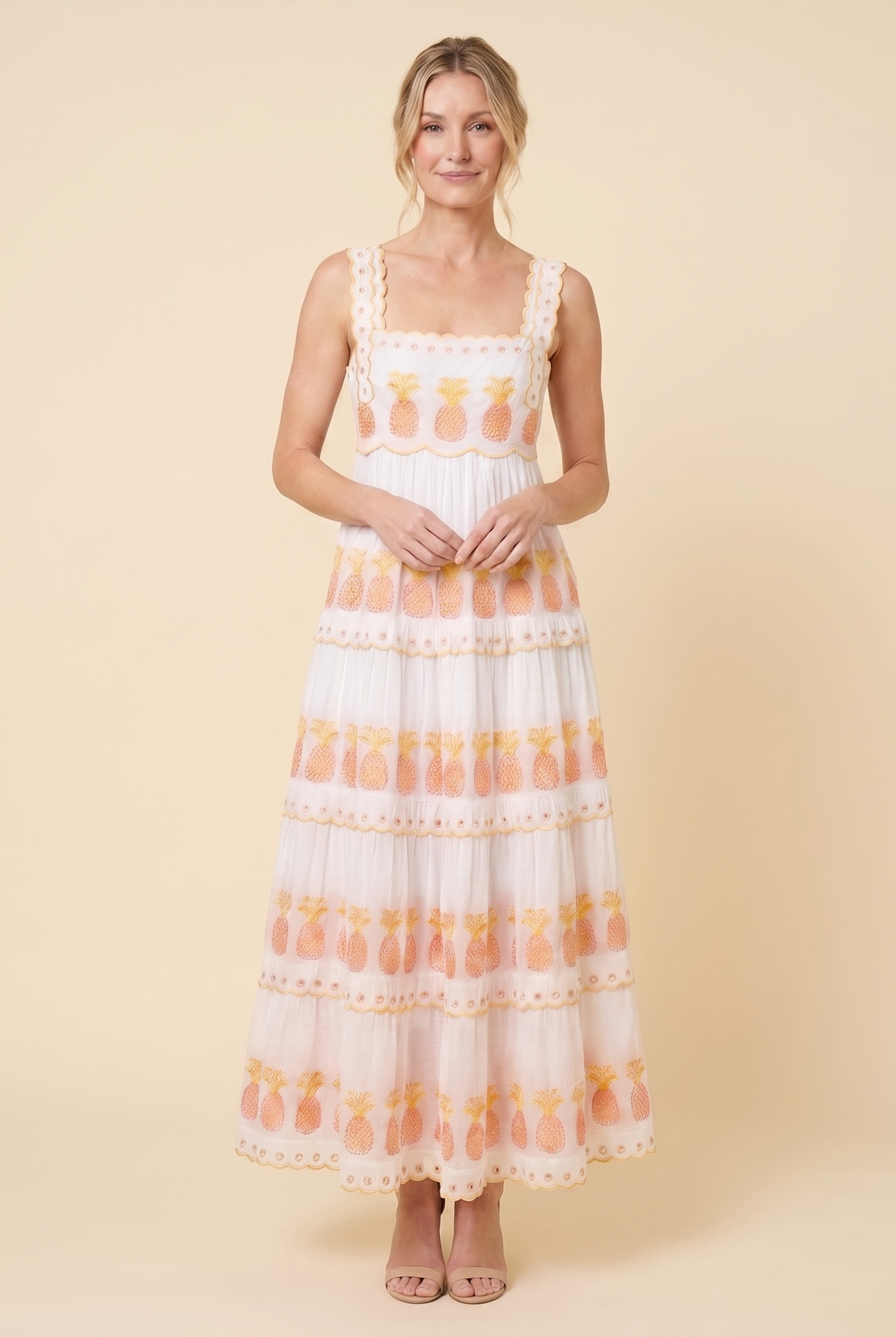 White pineapple-embroidered tiered maxi dress, relaxed pose on model