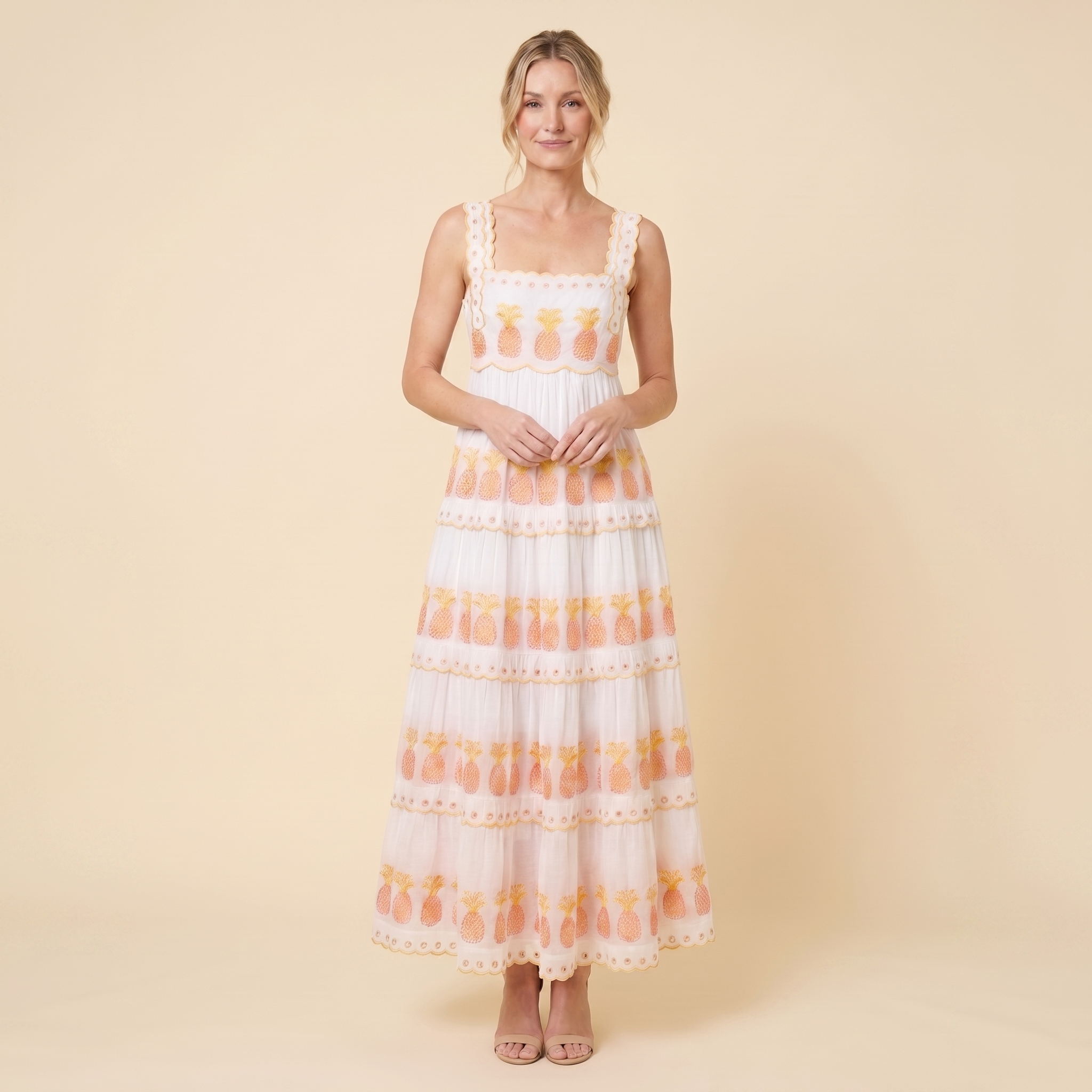 White pineapple-embroidered tiered maxi dress, relaxed pose on model