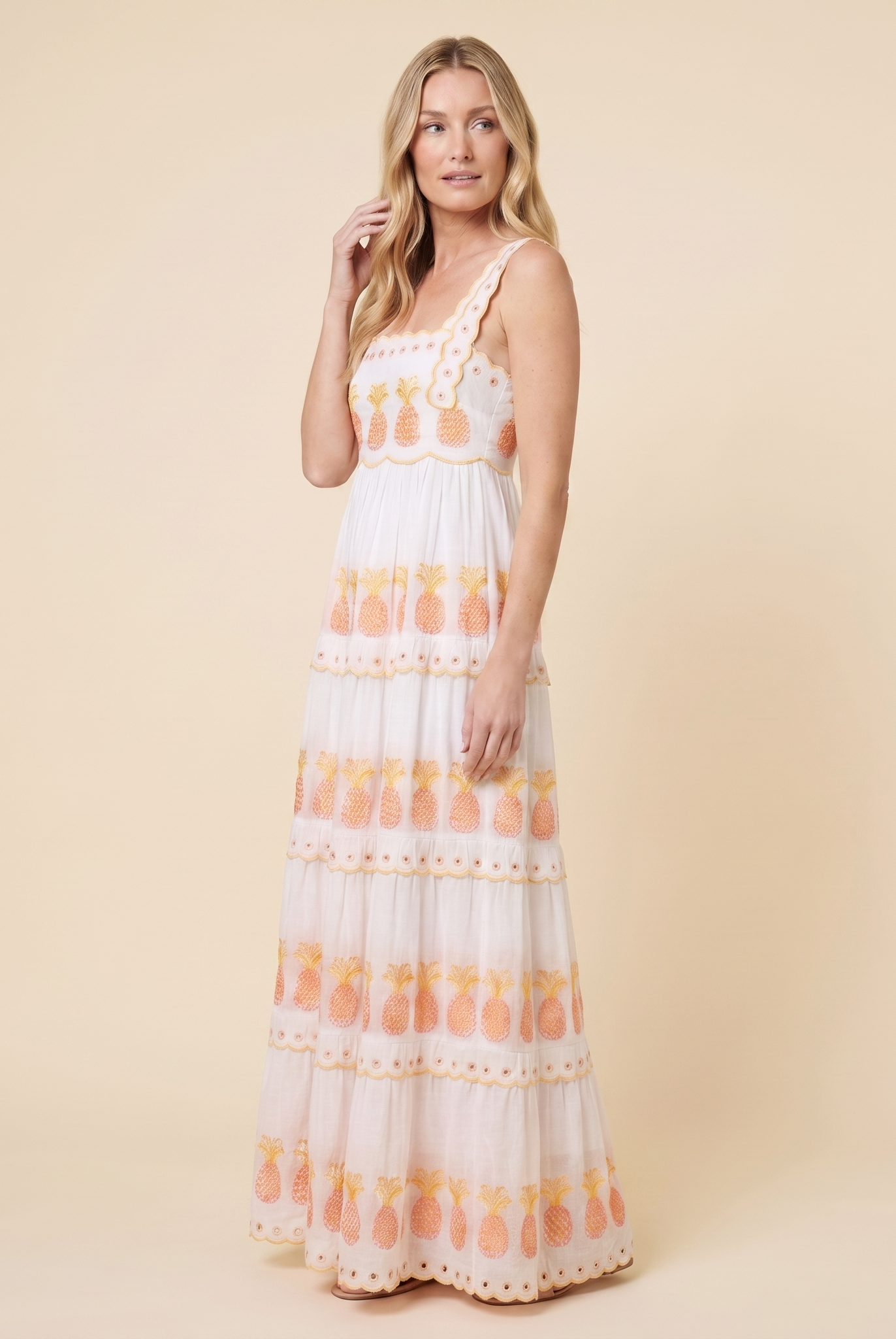 White square-neck tiered maxi dress, three-quarter side view on model