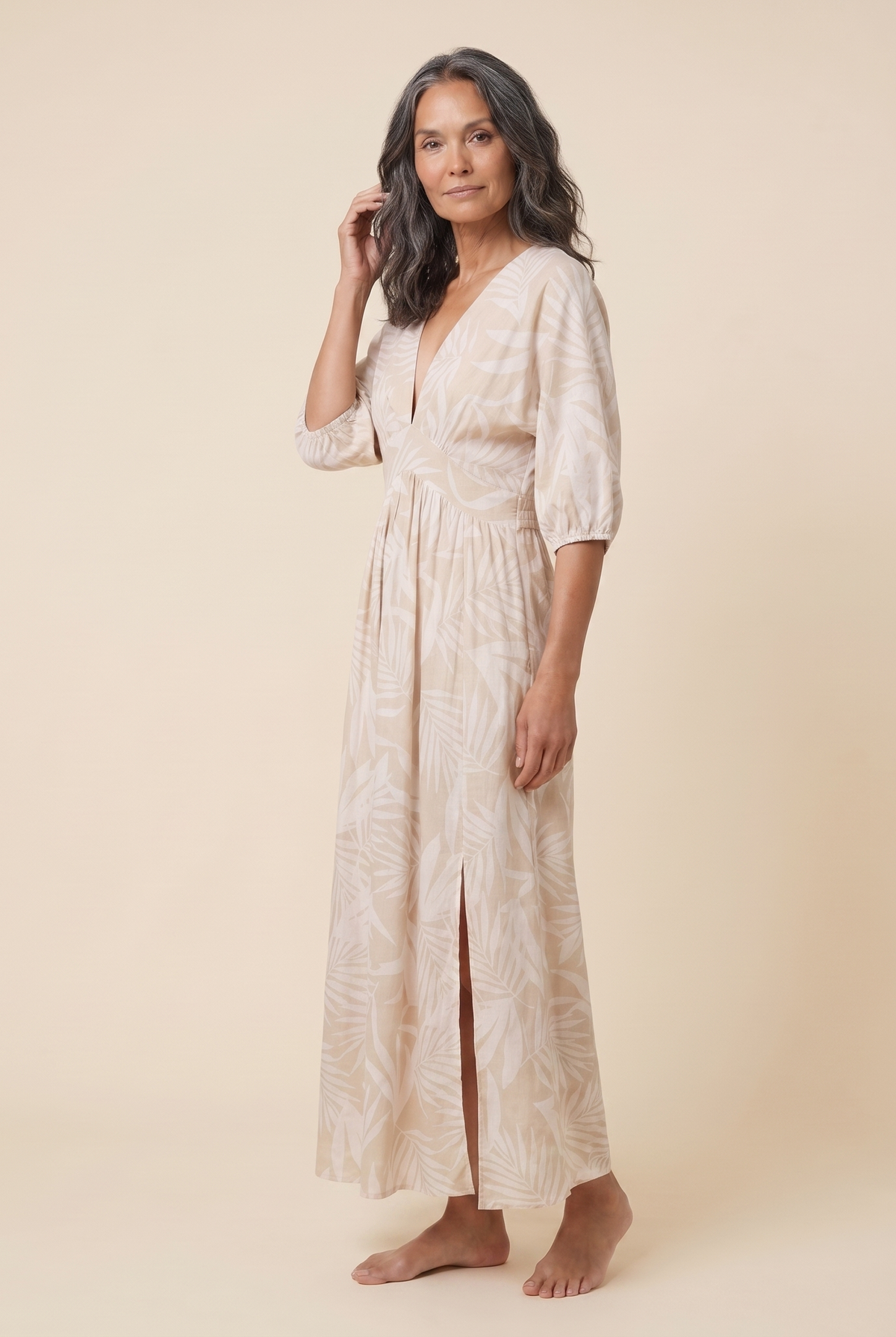 Beige tropical print A-line maxi dress, three-quarter side view on model
