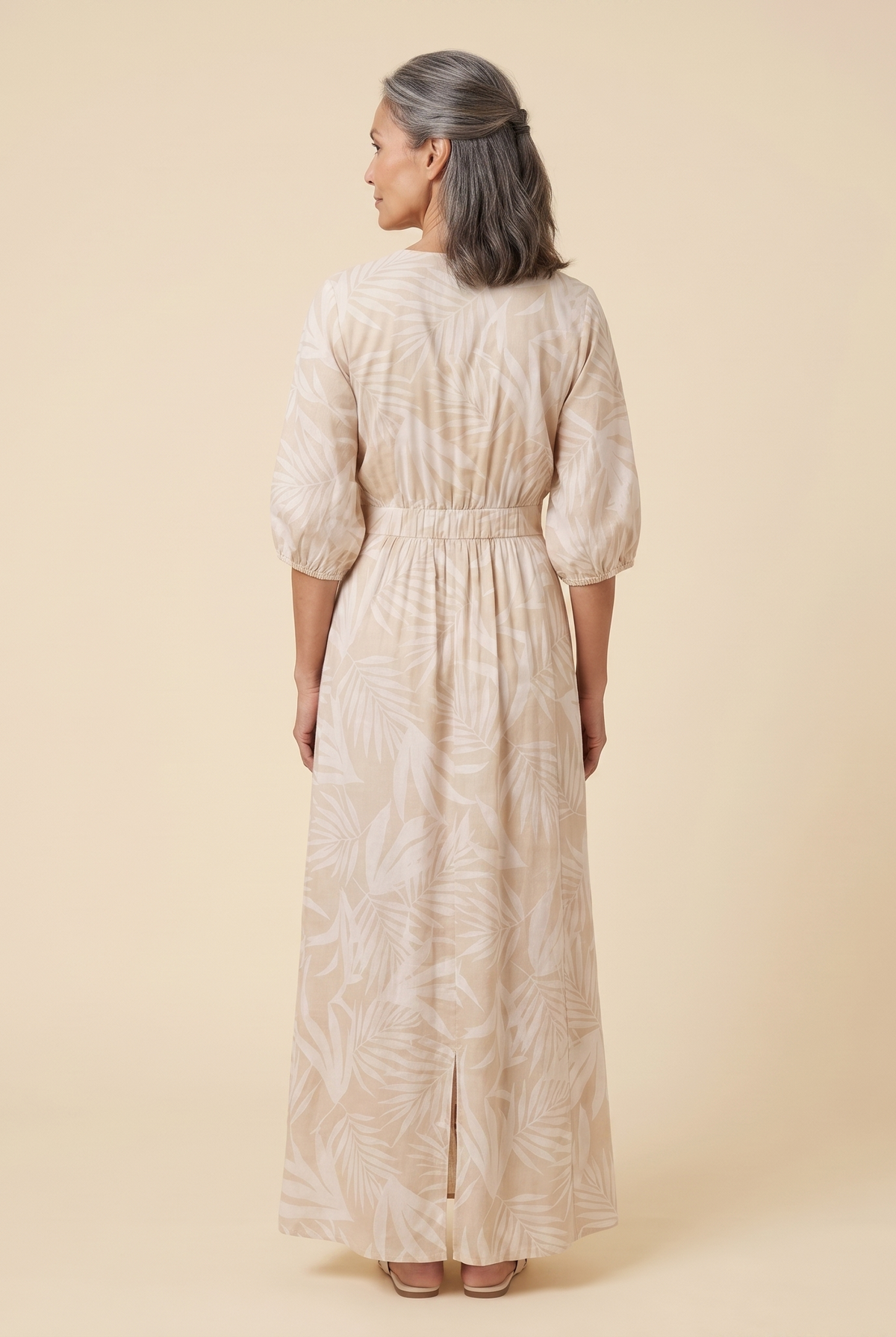 Beige tropical print maxi dress, back view on model showing silhouette