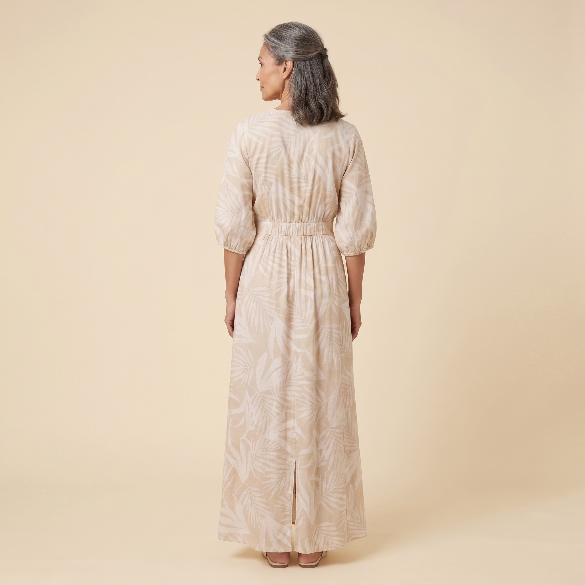 Beige tropical print maxi dress, back view on model showing silhouette