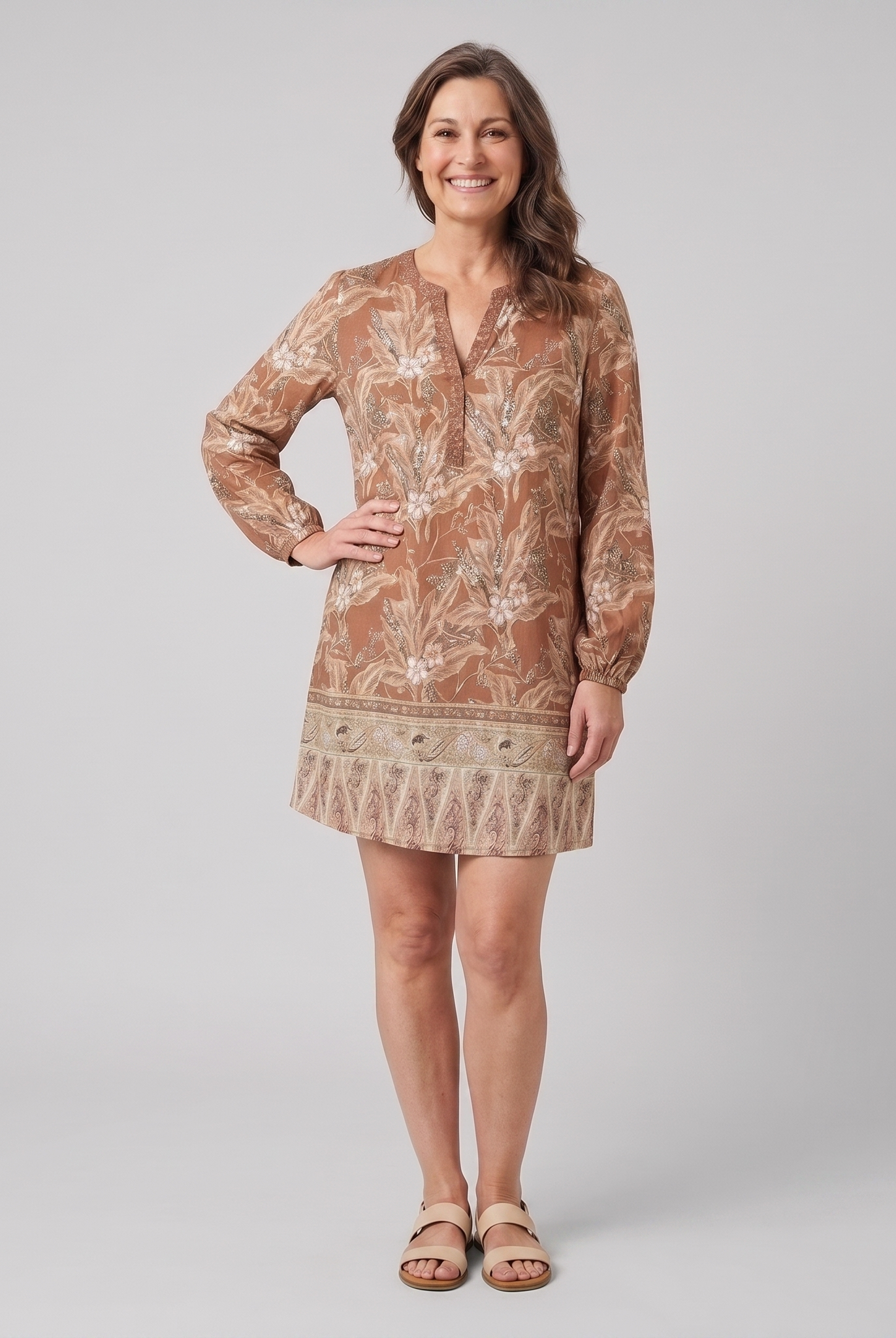 Women's brown floral V-neck long-sleeve shift mini dress, front view on model, grey studio background