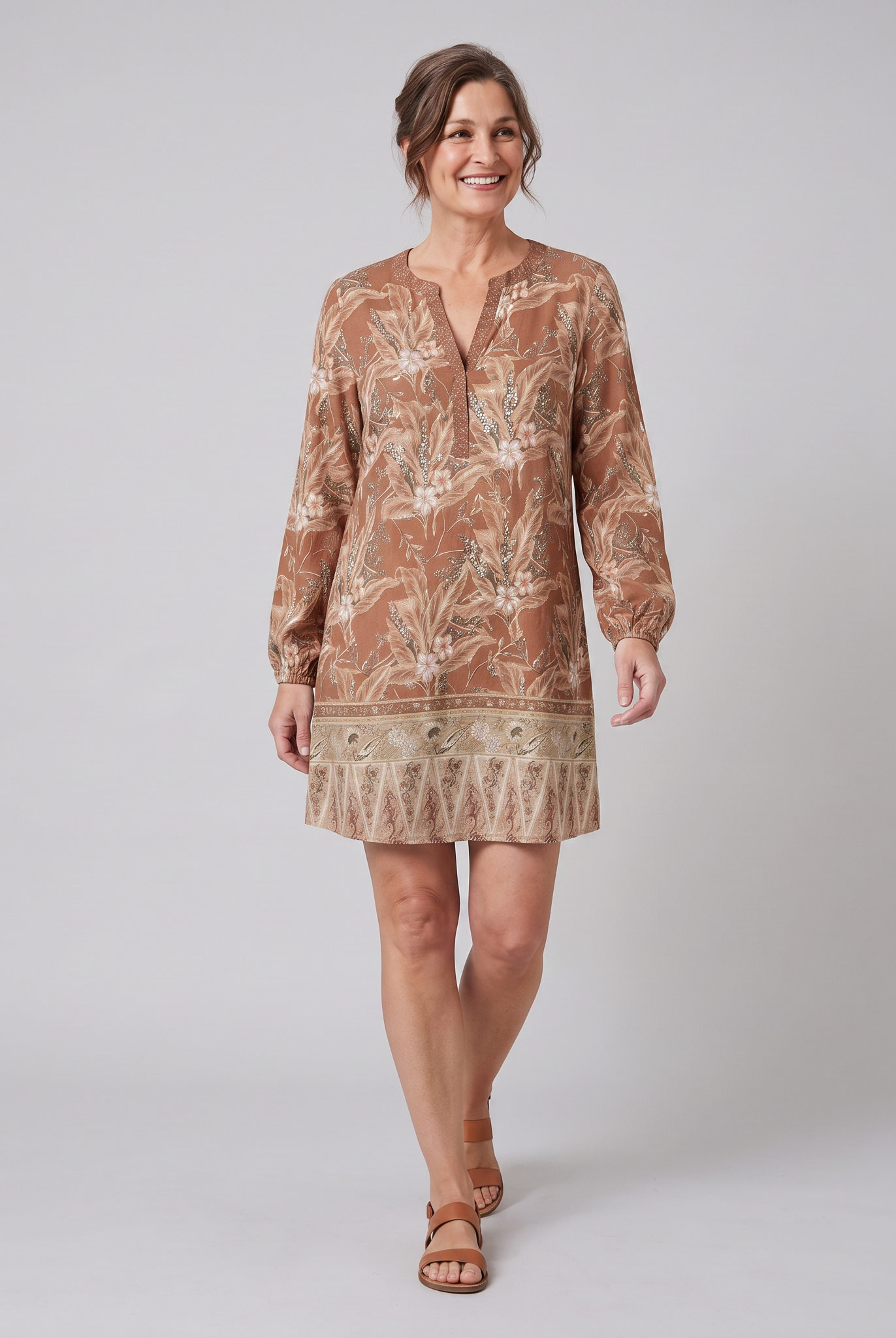 Brown floral shift mini dress, walking pose on model, grey studio background