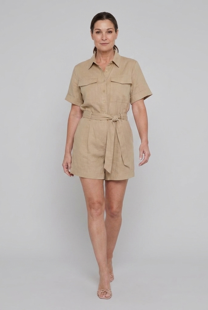 Beige utility romper with button front, walking pose on model
