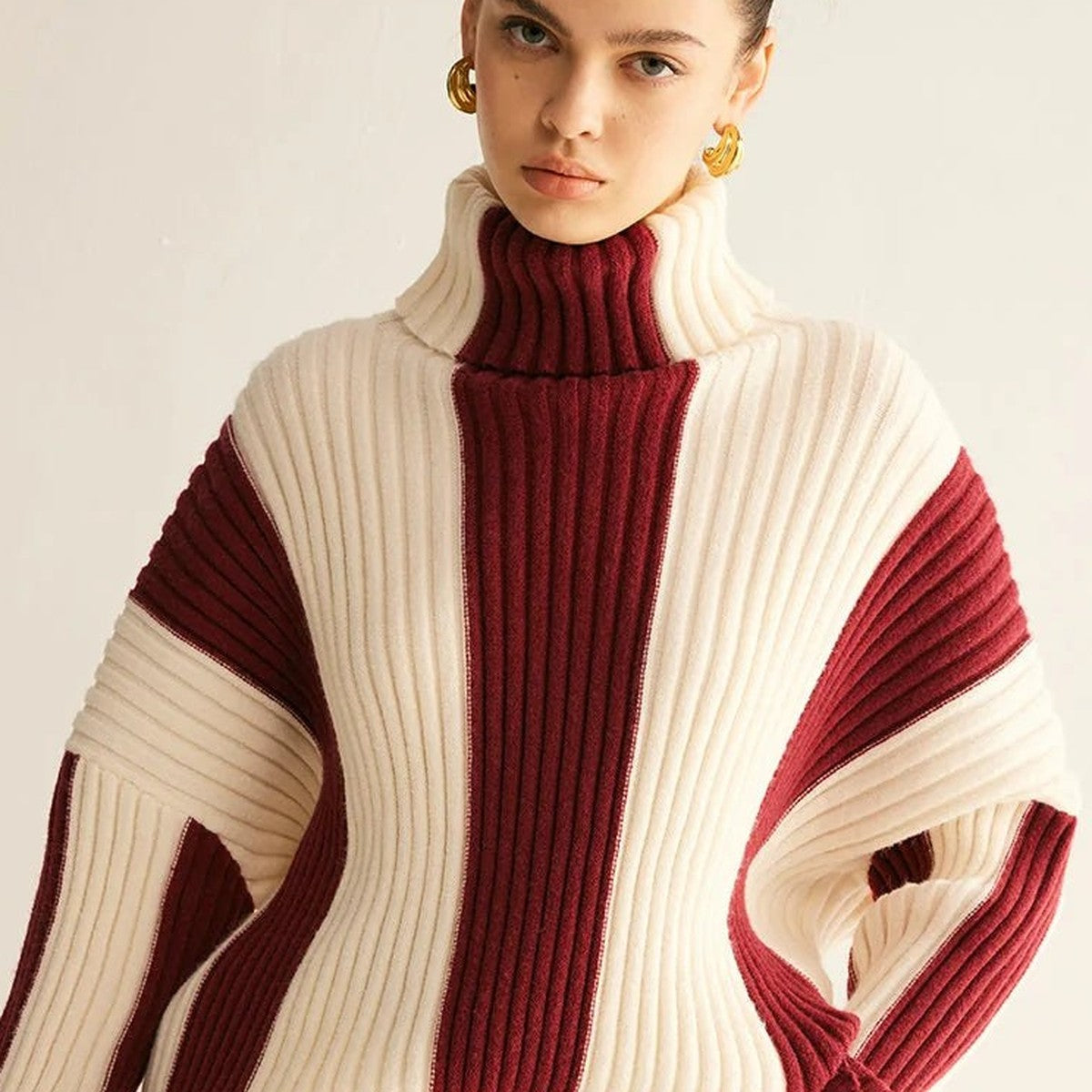 Close-up of women's colour block ribbed roll neck jumper