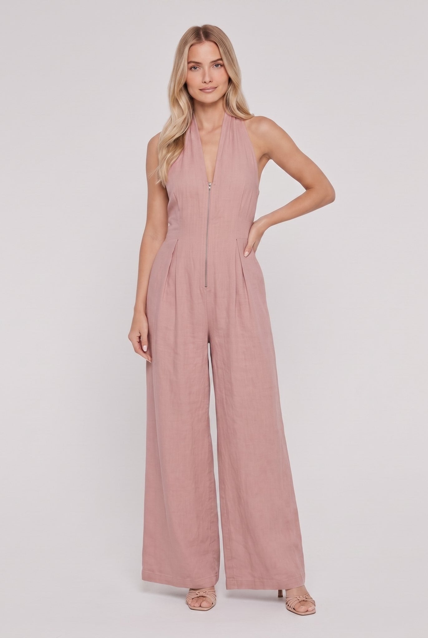 Dusty rose pink halter-neck wide-leg jumpsuit, front view, hand on hip