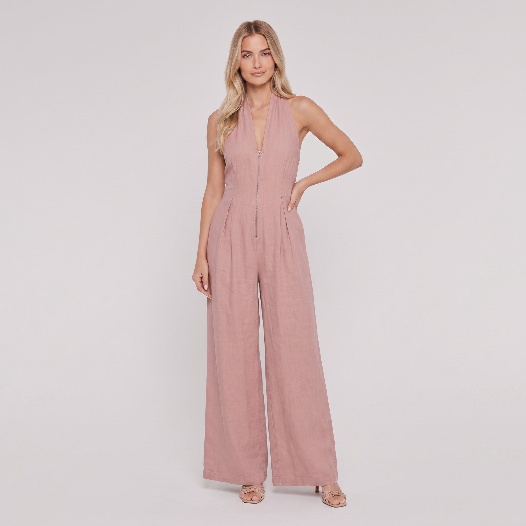 Dusty rose pink halter-neck wide-leg jumpsuit, front view, hand on hip