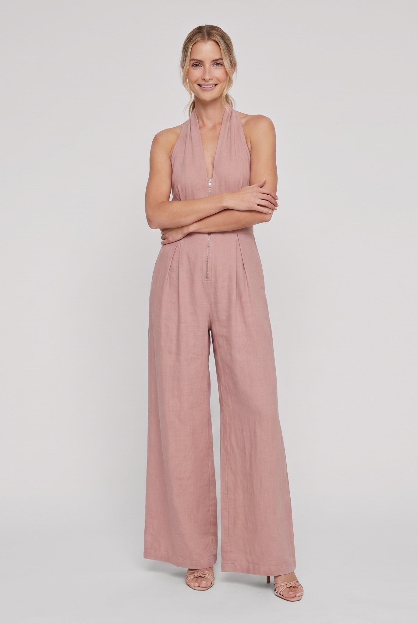 Dusty rose pink halter-neck wide-leg jumpsuit, arms crossed