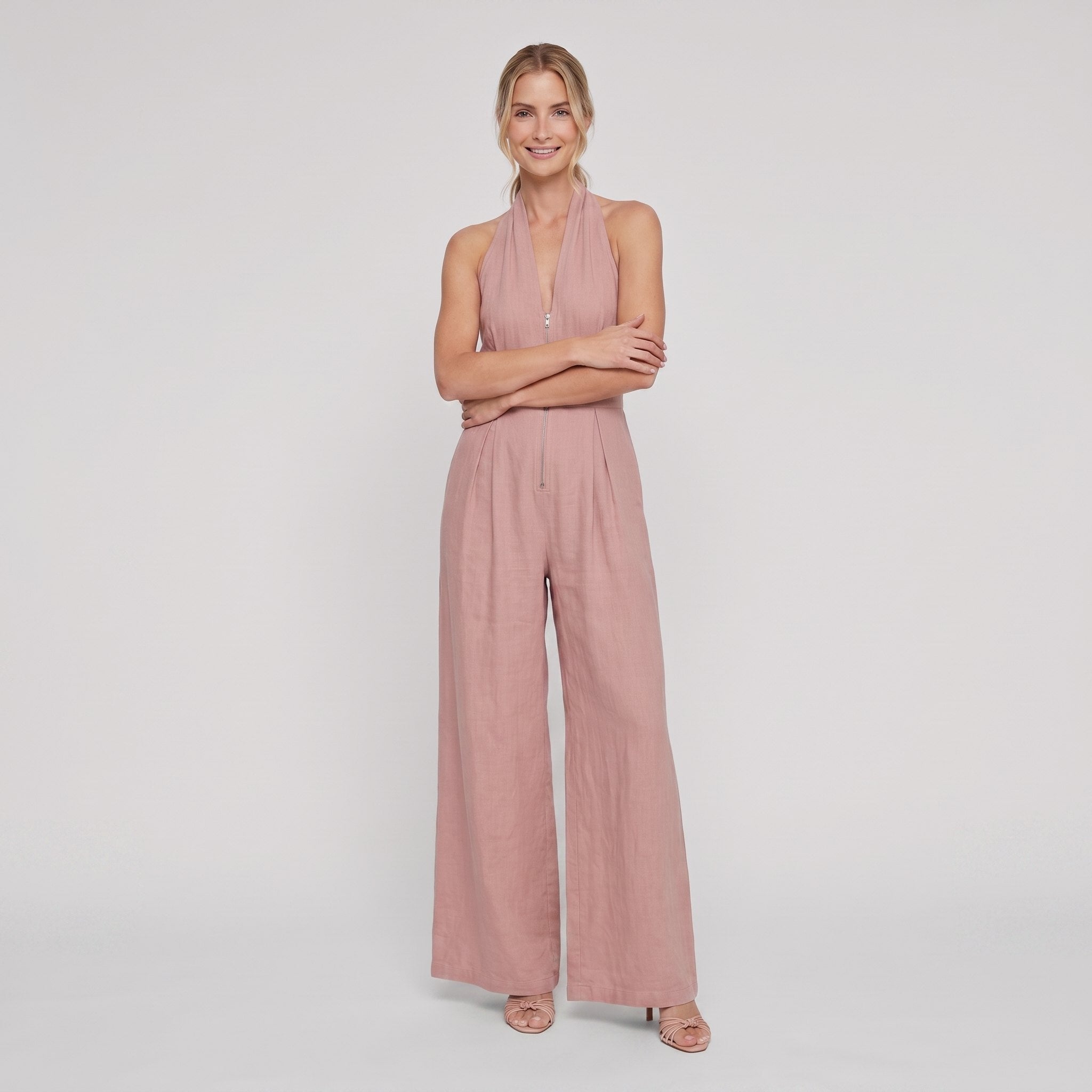 Dusty rose pink halter-neck wide-leg jumpsuit, arms crossed