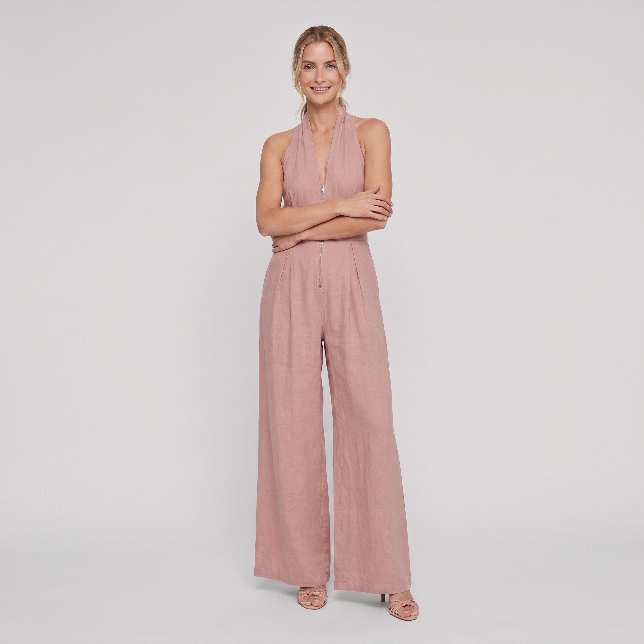 Dusty rose pink halter-neck wide-leg jumpsuit, arms crossed