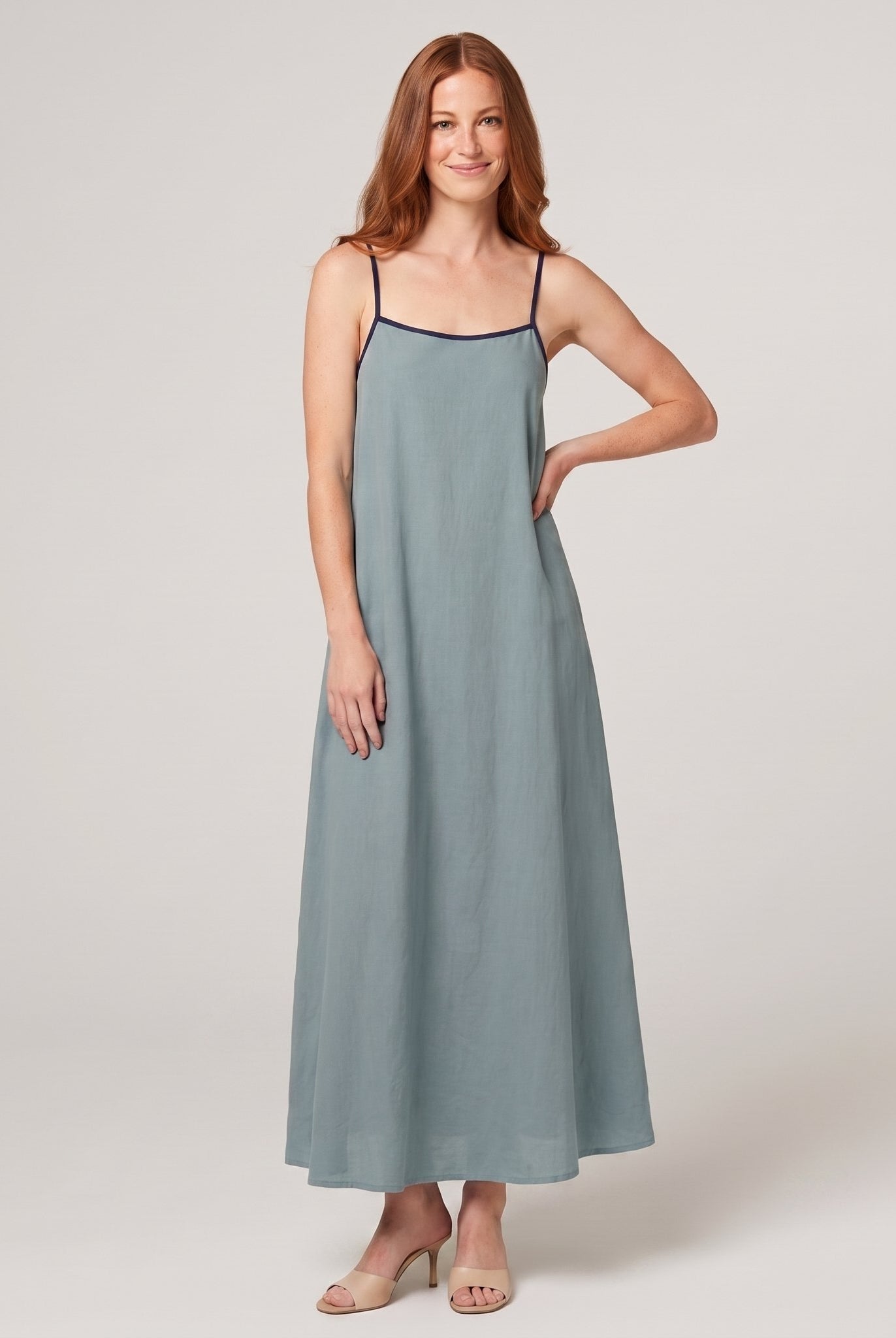 Dusty sage-blue spaghetti-strap maxi slip dress with navy trim, front view