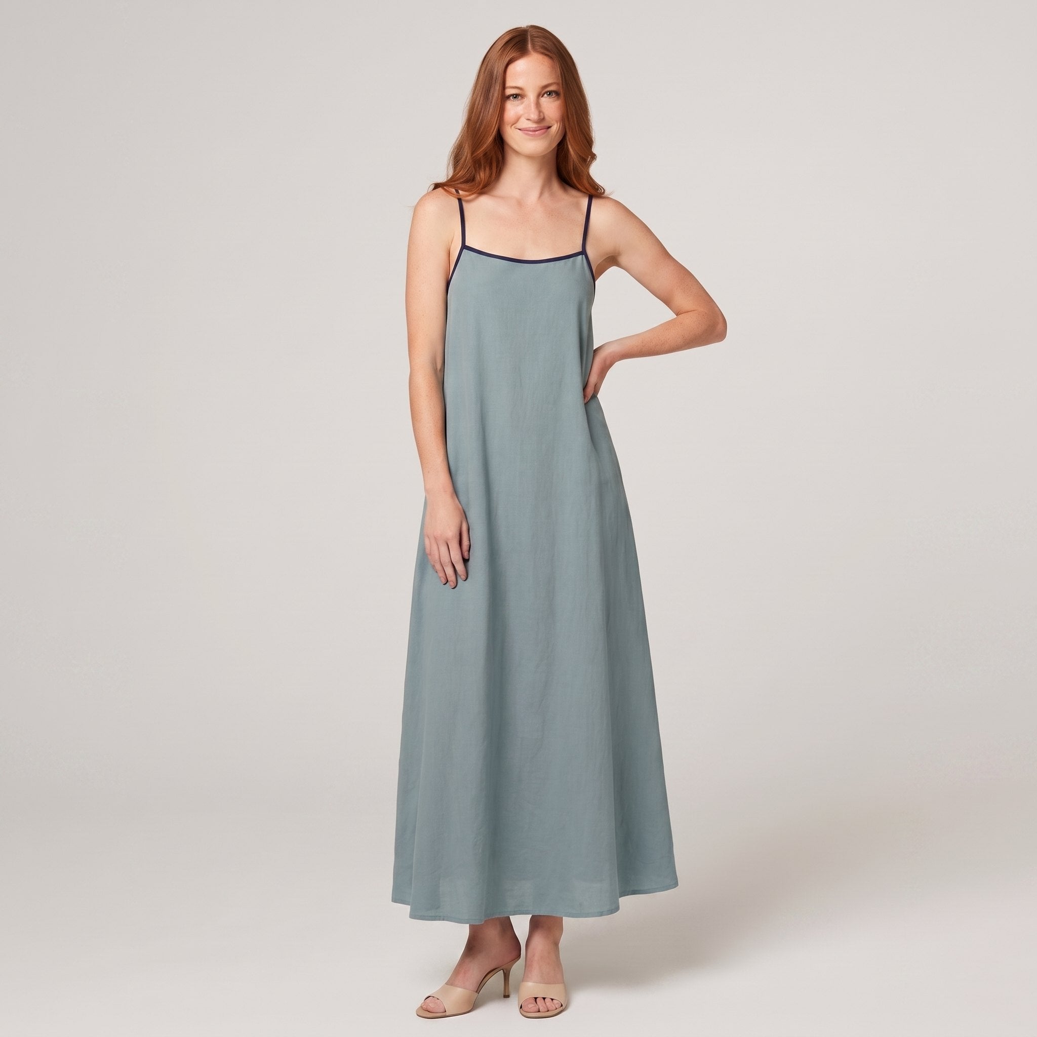 Dusty sage-blue spaghetti-strap maxi slip dress with navy trim, front view