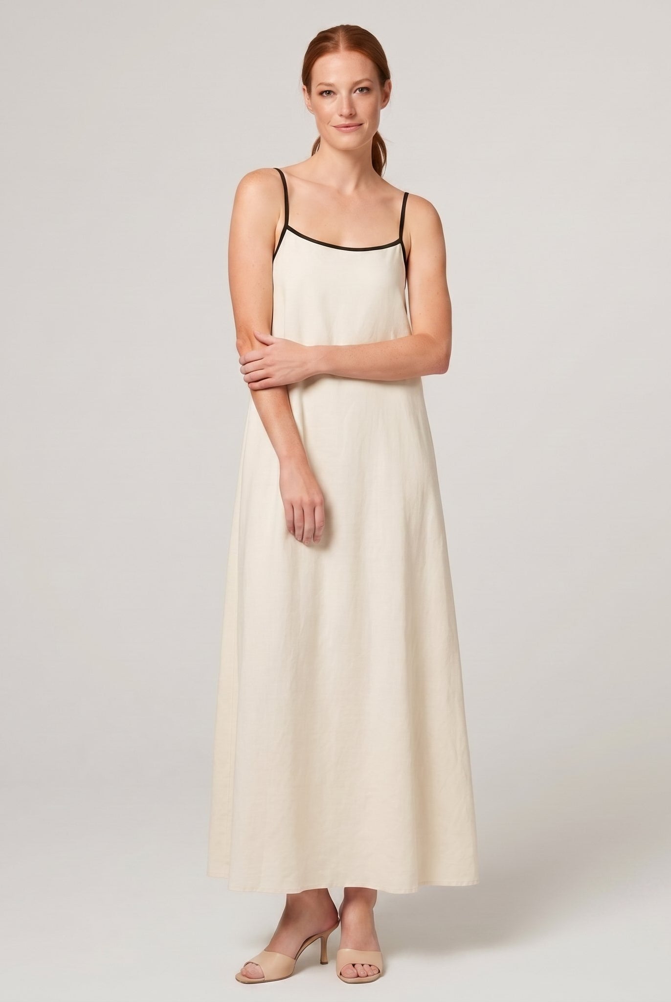Cream ivory spaghetti-strap maxi slip dress with black trim, front view
