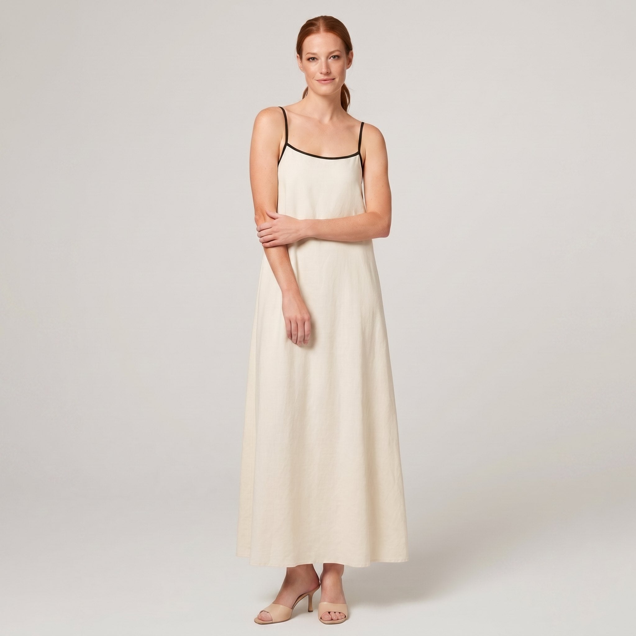 Cream ivory spaghetti-strap maxi slip dress with black trim, front view
