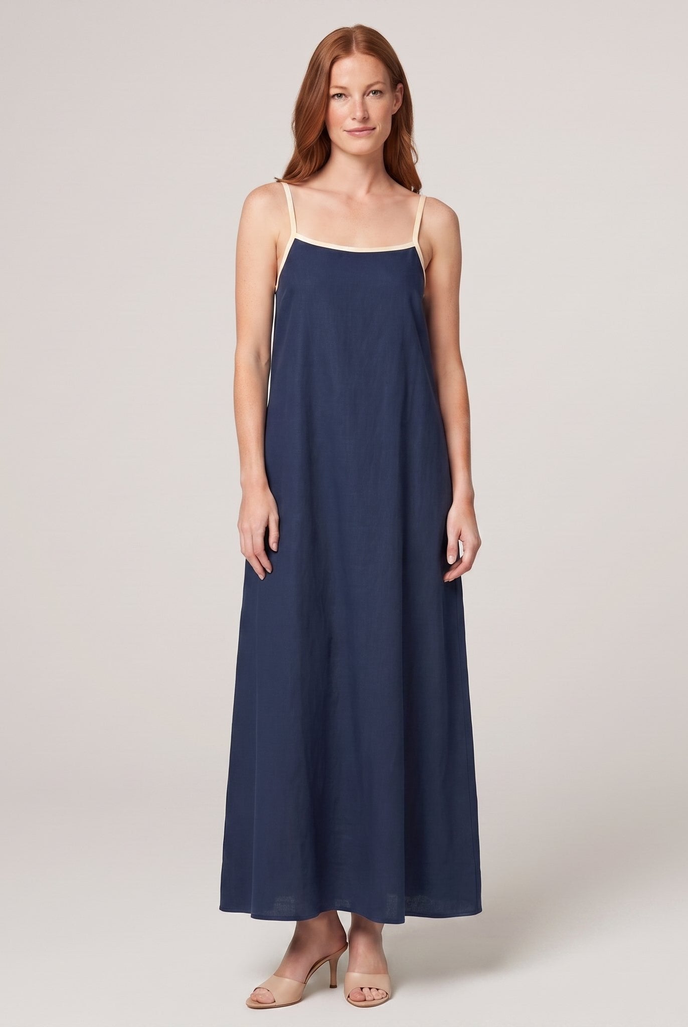 Navy spaghetti-strap maxi slip dress with cream trim, front view