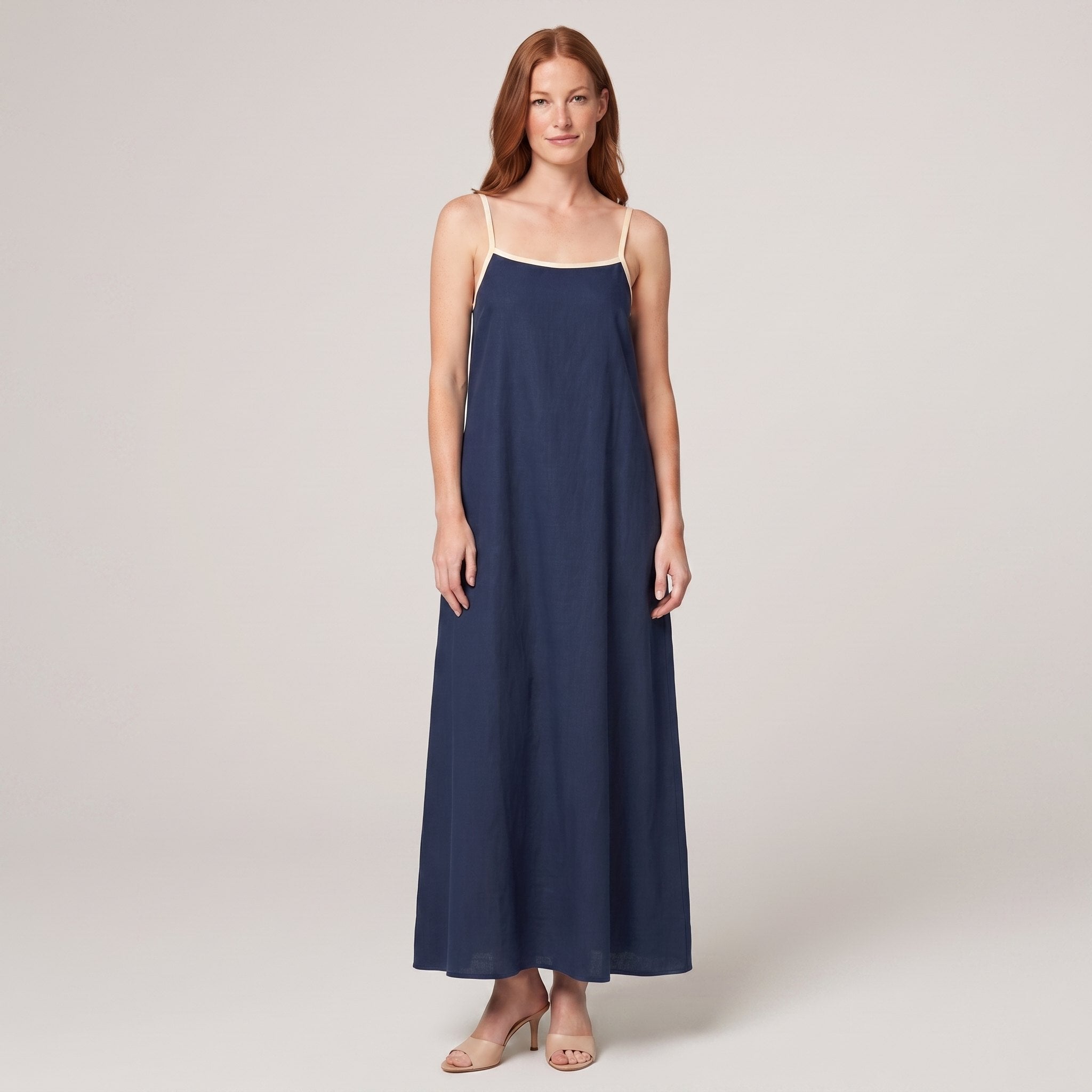 Navy spaghetti-strap maxi slip dress with cream trim, front view