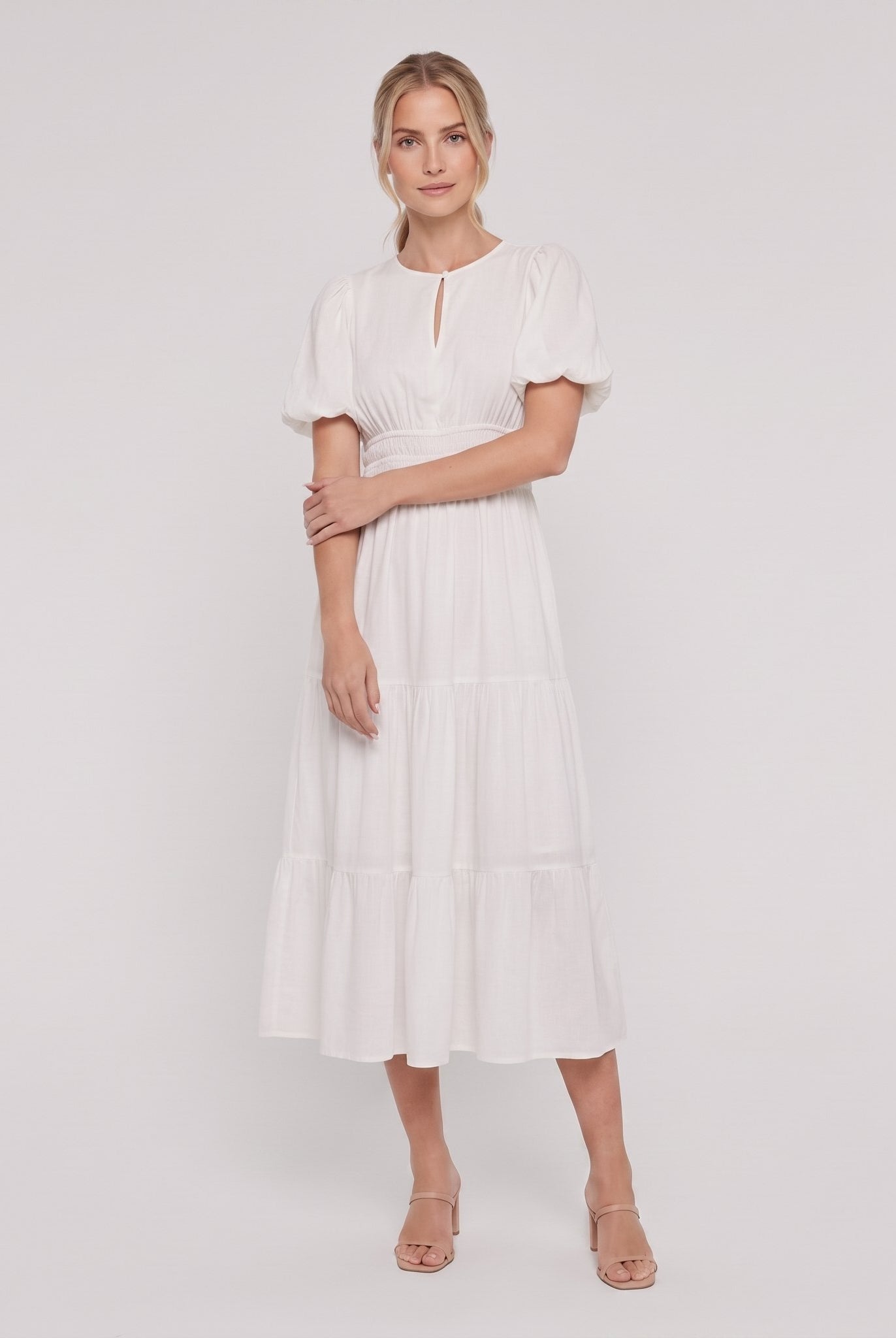 White tiered cotton midi dress, side pose on model