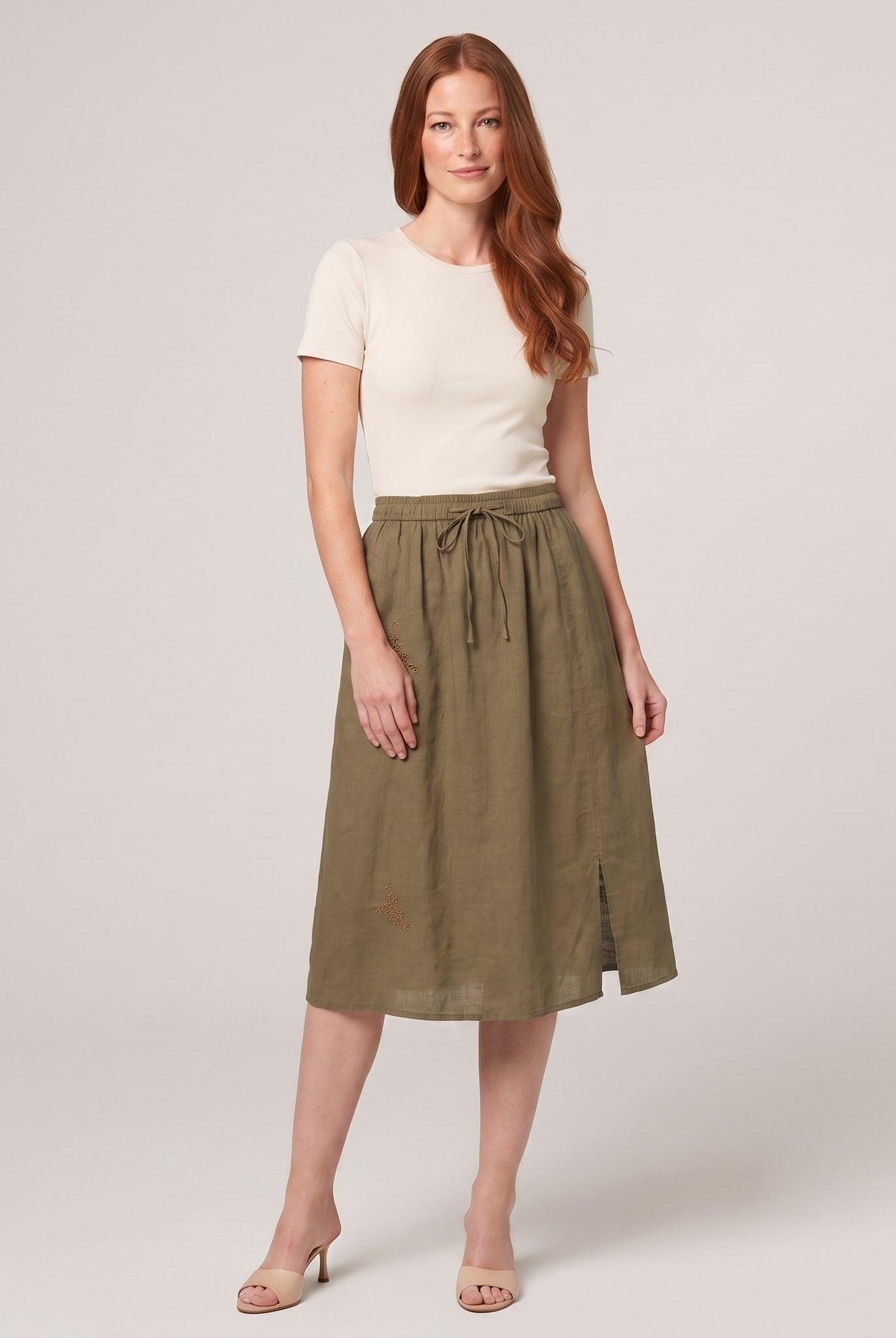 Khaki green linen A-line knee-length drawstring skirt, front view on model