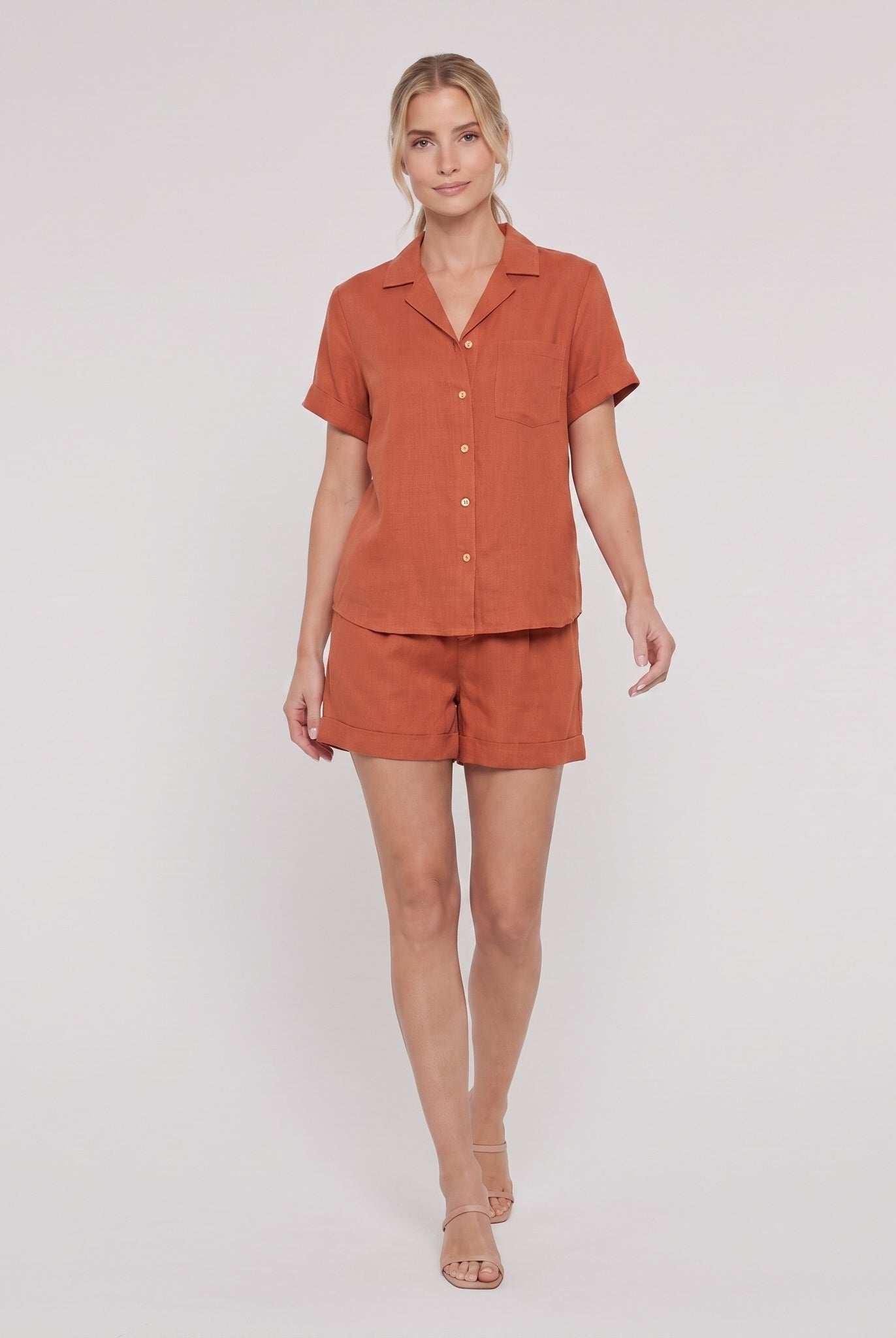 Rust orange linen camp-collar shirt and high-waist shorts set, front view on model