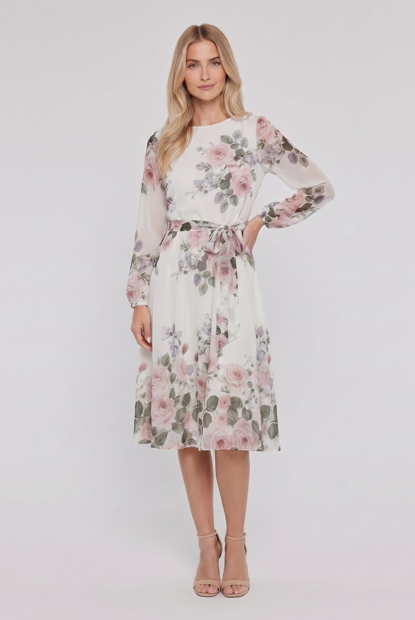 Model wearing white floral A-line midi dress with tie belt, hand on hip