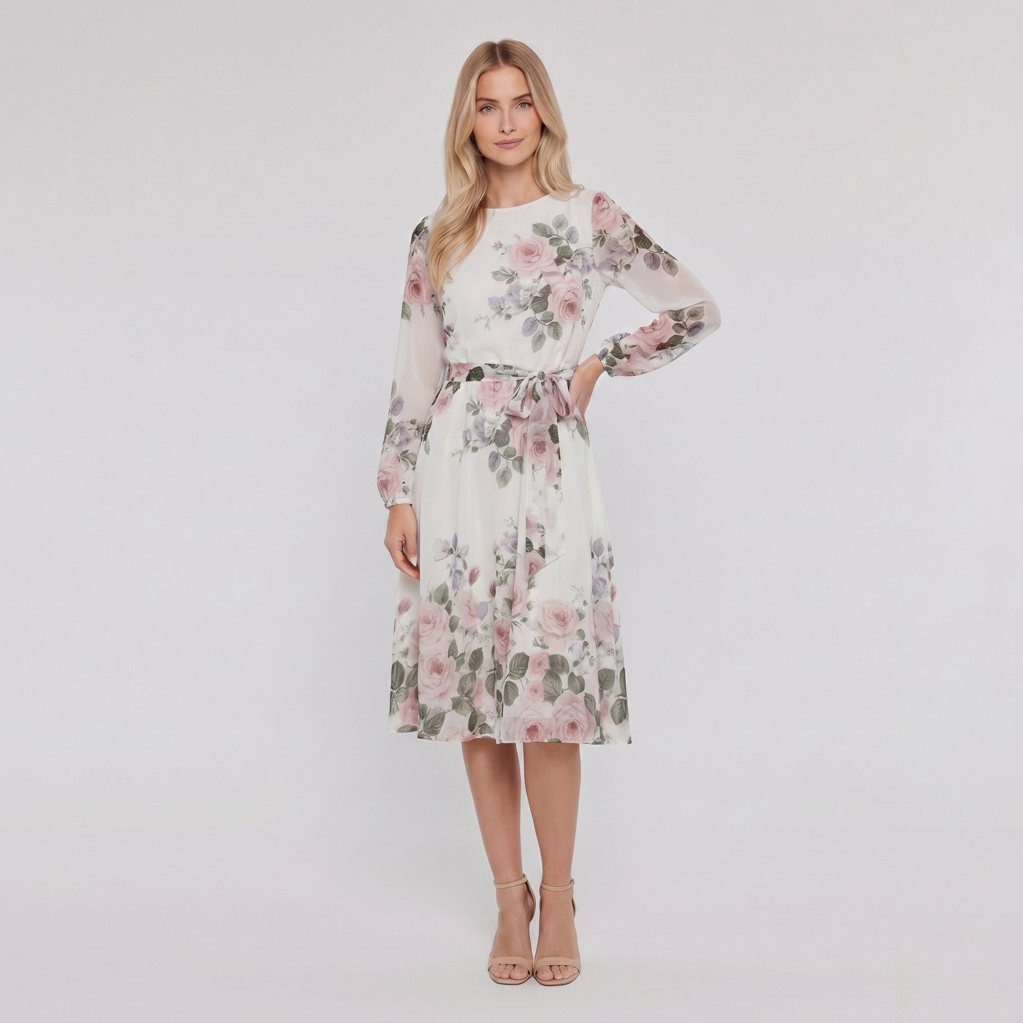 Model wearing white floral A-line midi dress with tie belt, hand on hip
