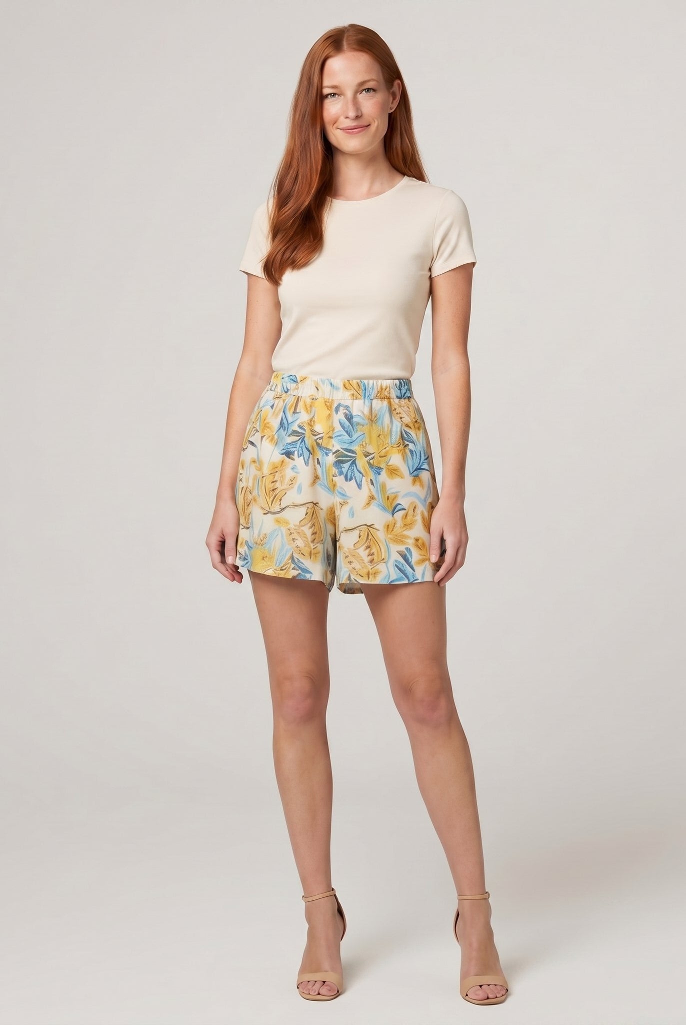 Pamela Boutique beige floral A-line pleated shorts, model view