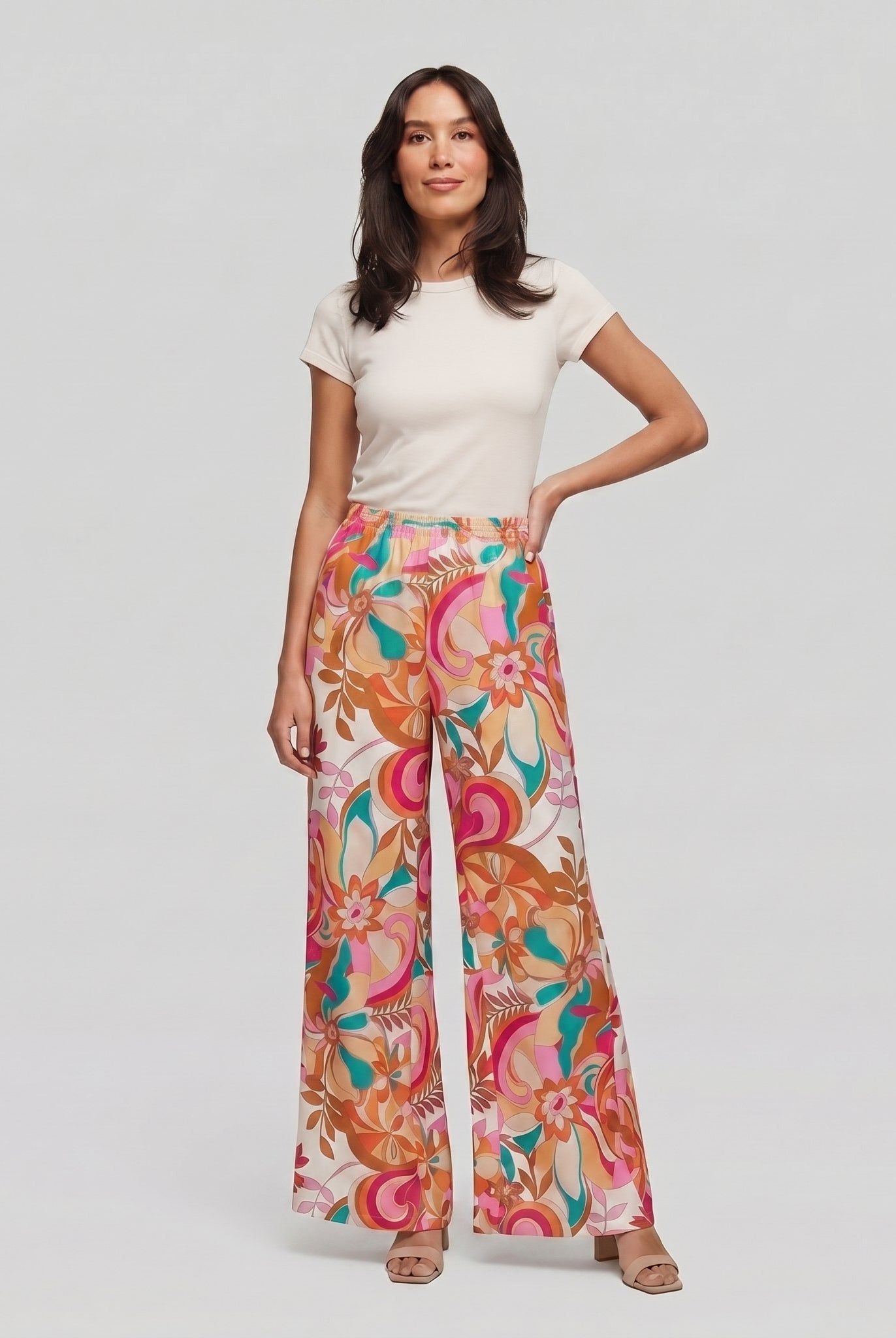 Pamela Boutique pink floral wide-leg flared trousers, model front view