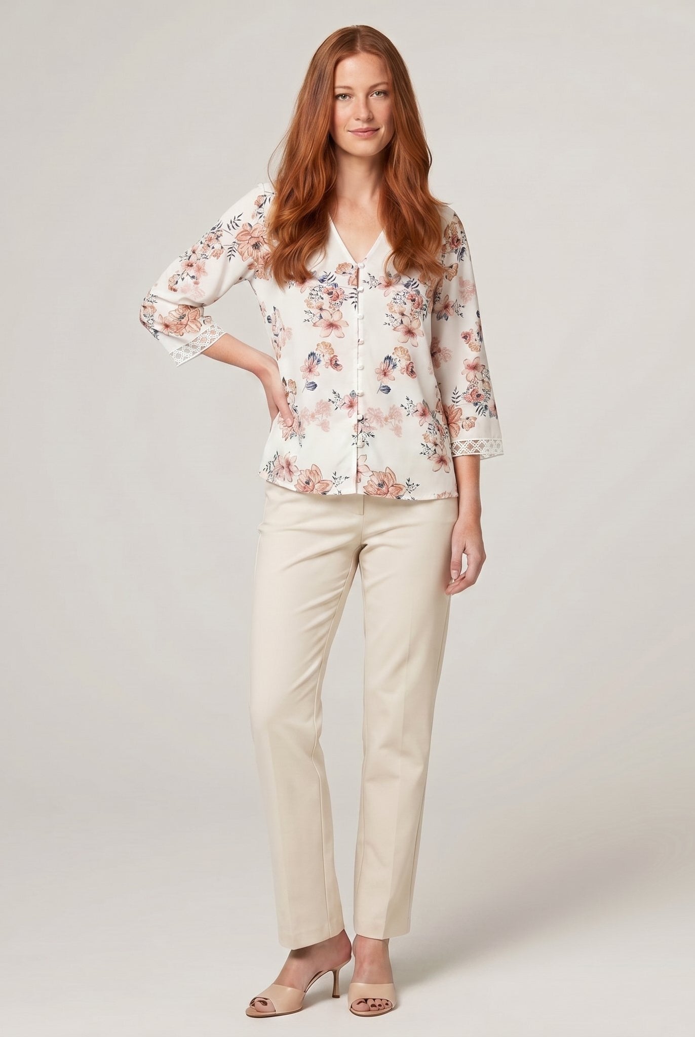 Pamela Boutique floral print V-neck blouse with crochet trim, model front view