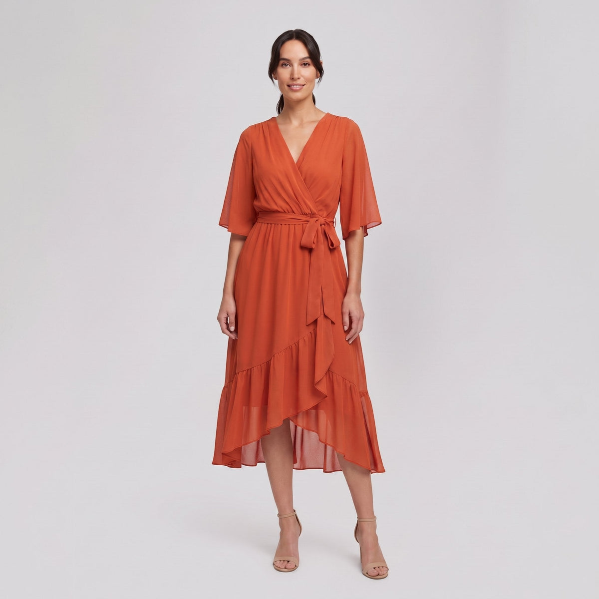 Burnt orange Gina wrap midi dress with V-neck and flutter sleeves on model
