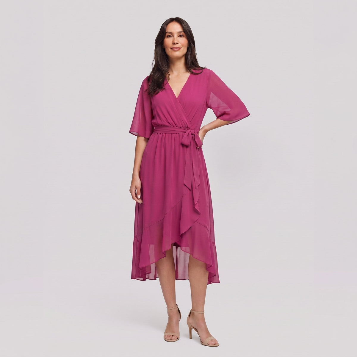 Fuchsia pink Gina wrap midi dress with V-neck and flutter sleeves on model