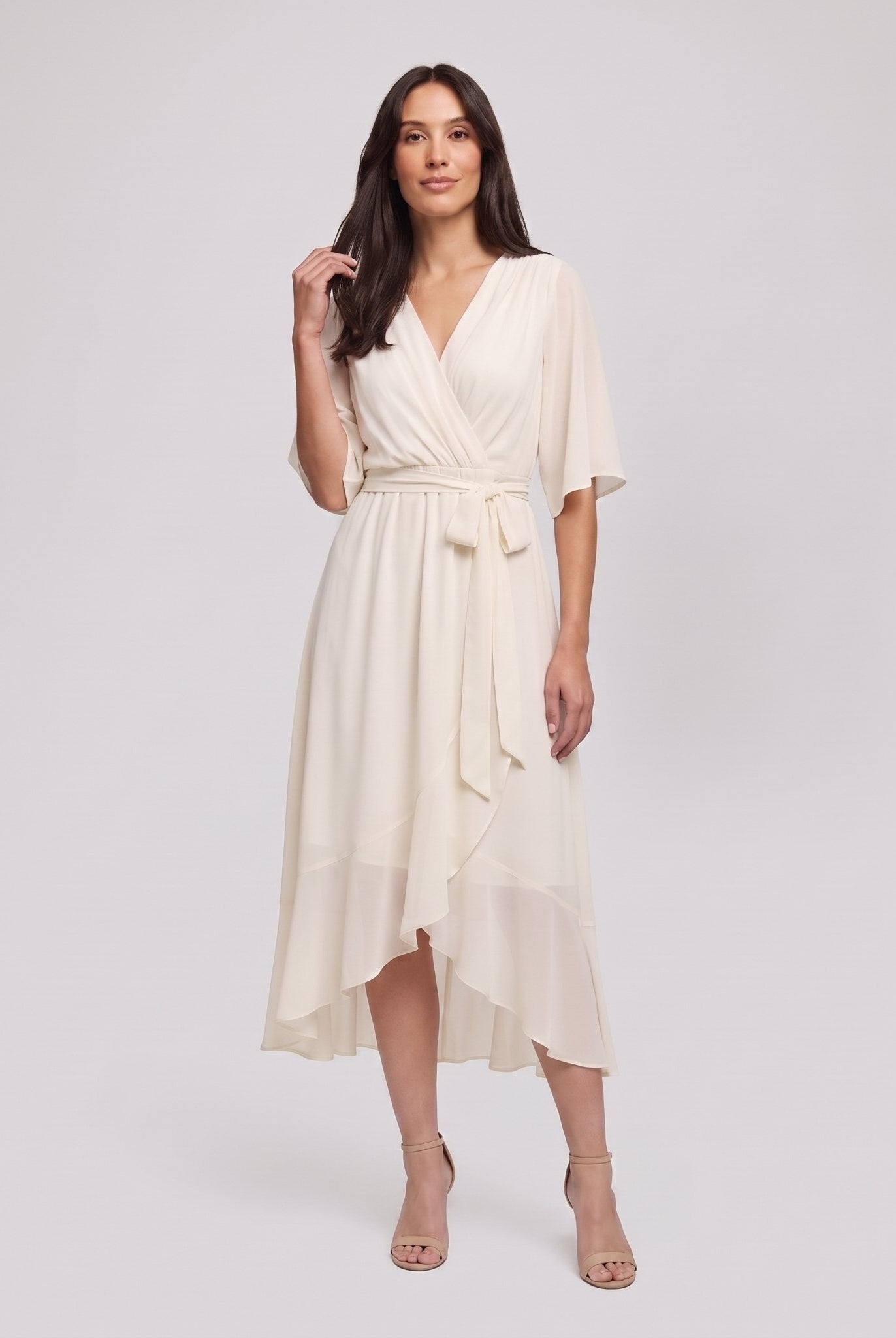 Ivory white Gina wrap midi dress with V-neck and flutter sleeves on model
