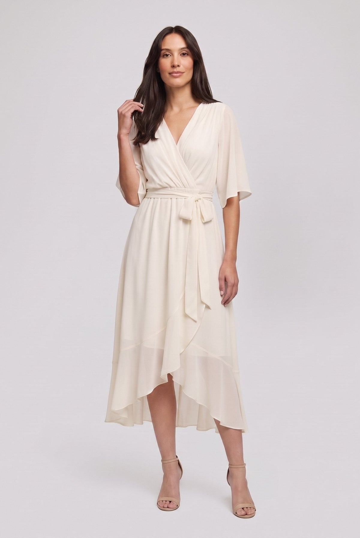 Ivory white Gina wrap midi dress with V-neck and flutter sleeves on model