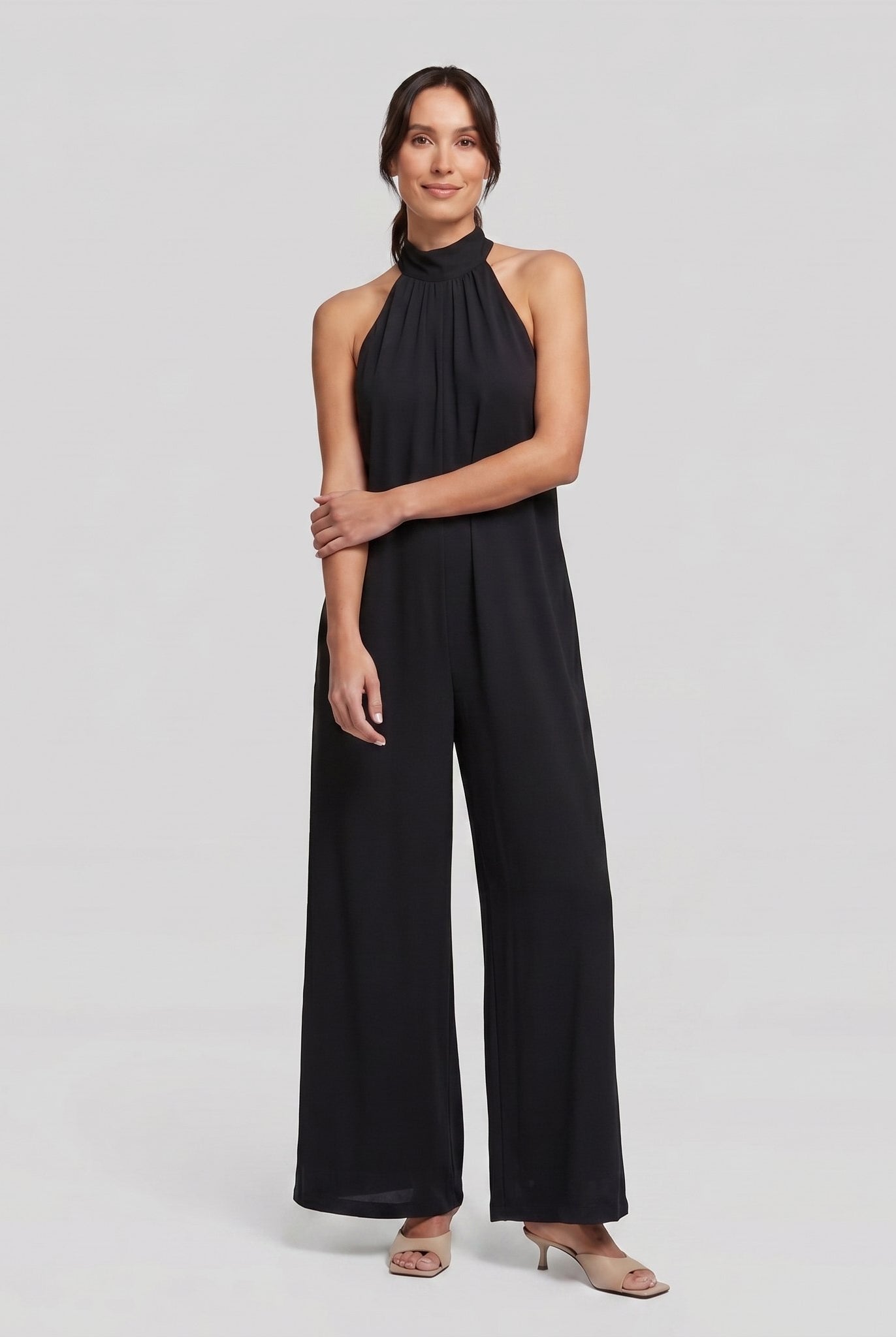 Black halter neck wide leg jumpsuit on model, full length - Pamela Boutique