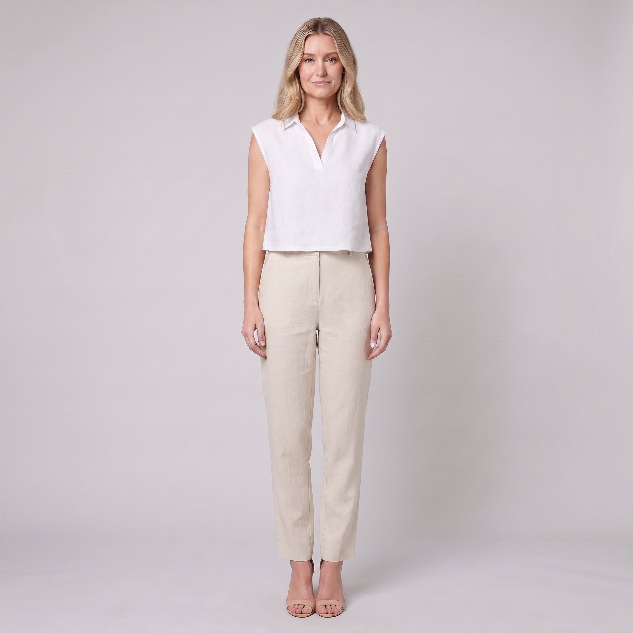White sleeveless linen crop top with open collar, front view on model