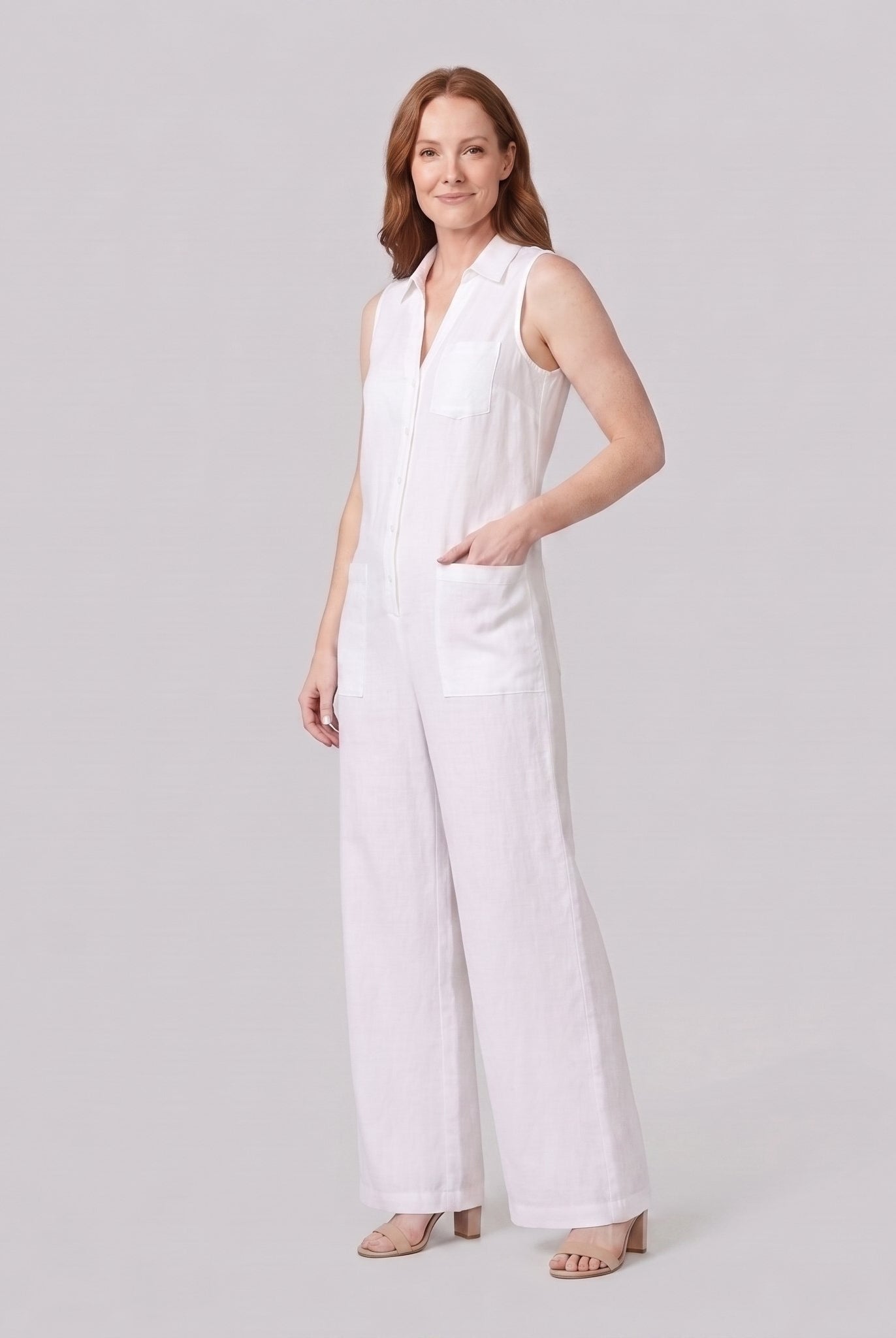 White wide-leg linen jumpsuit, side view with hand in pocket on model