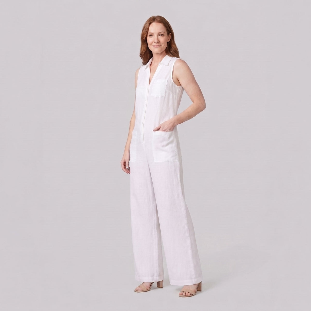 White wide-leg linen jumpsuit, side view with hand in pocket on model