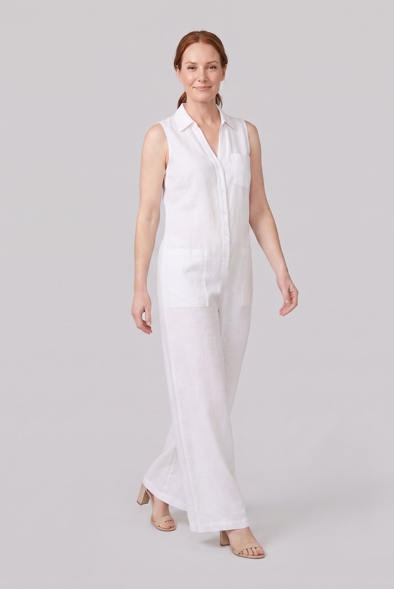 White wide-leg linen jumpsuit, walking pose on model