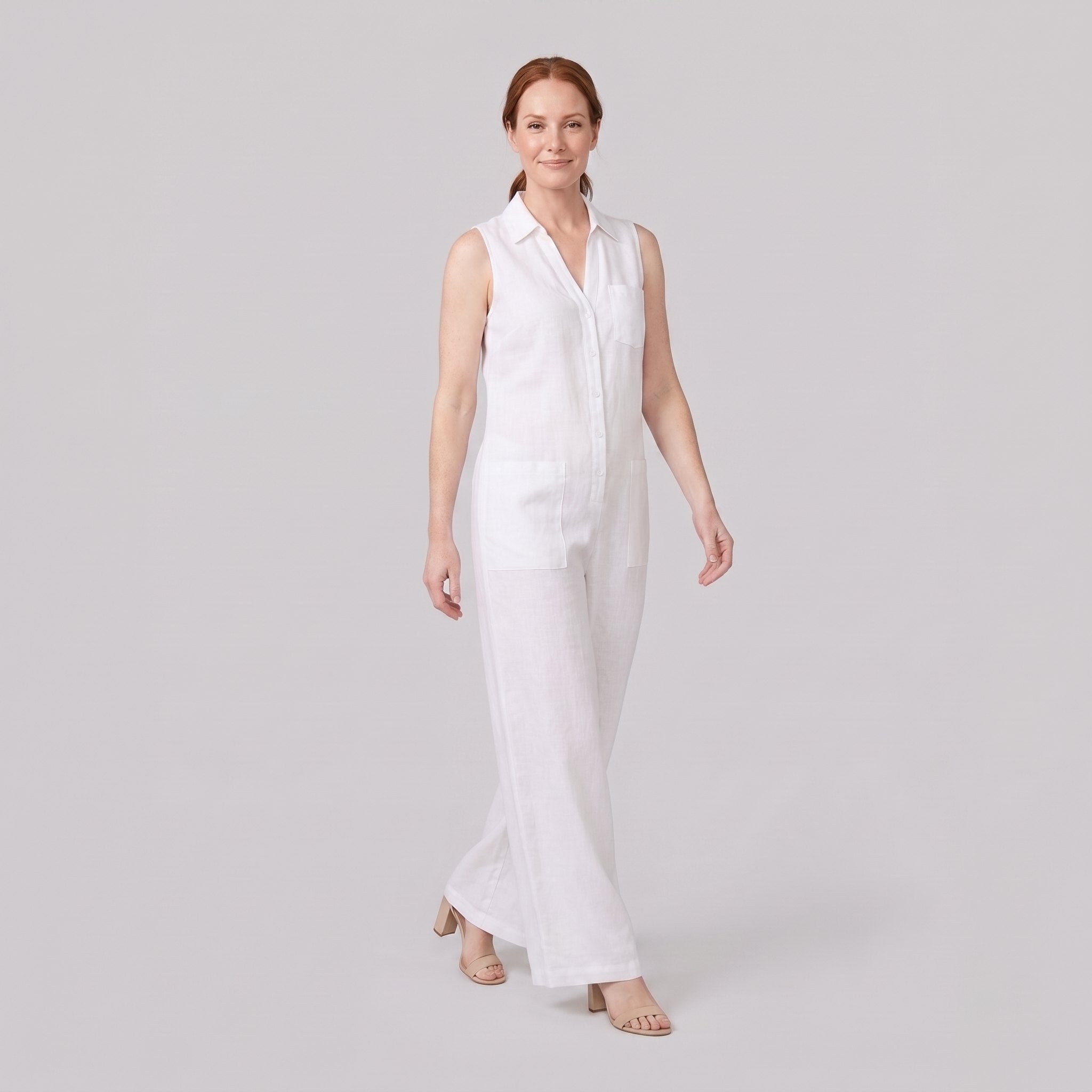 White wide-leg linen jumpsuit, walking pose on model