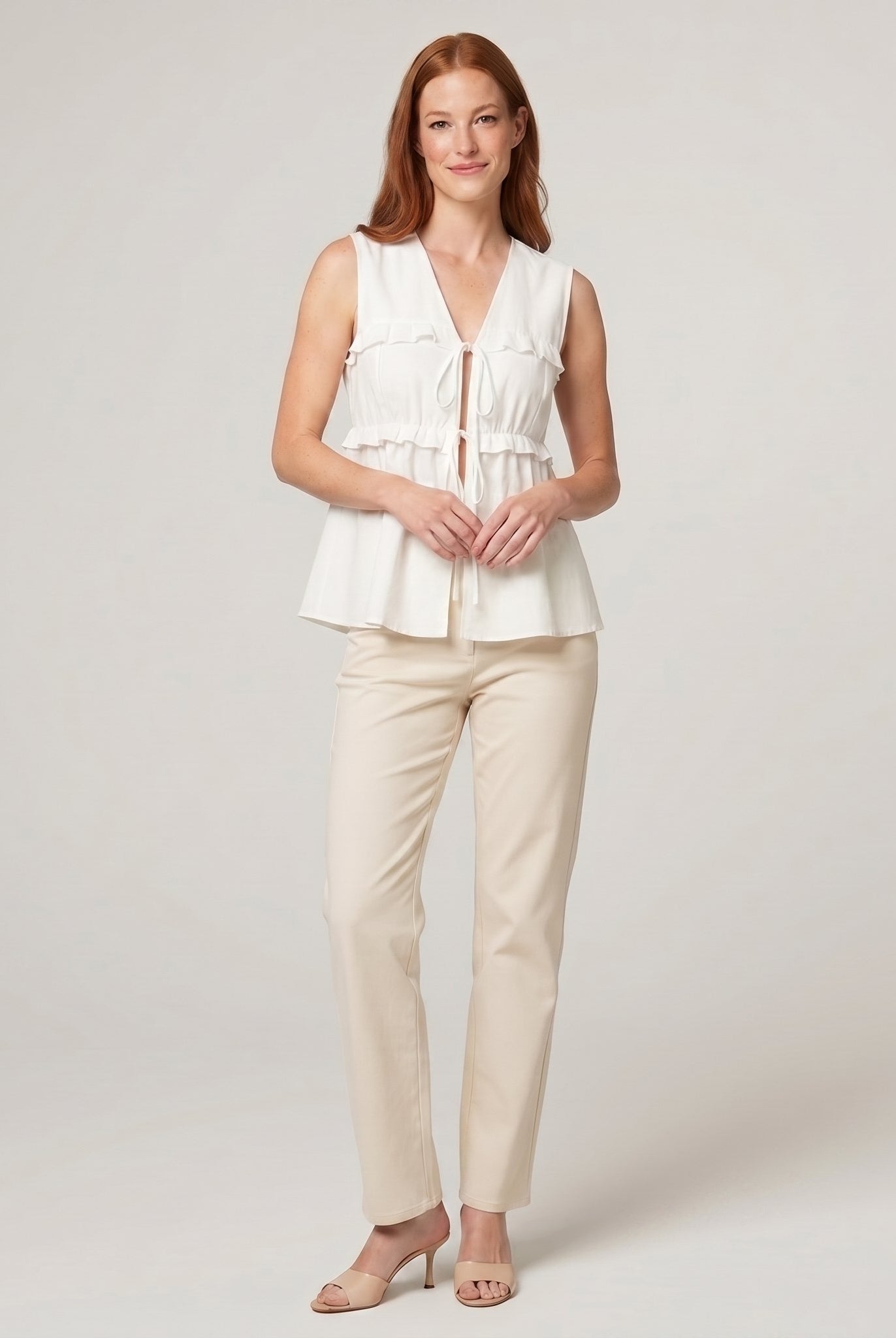 Pamela Boutique white peplum sleeveless V-neck top, model view