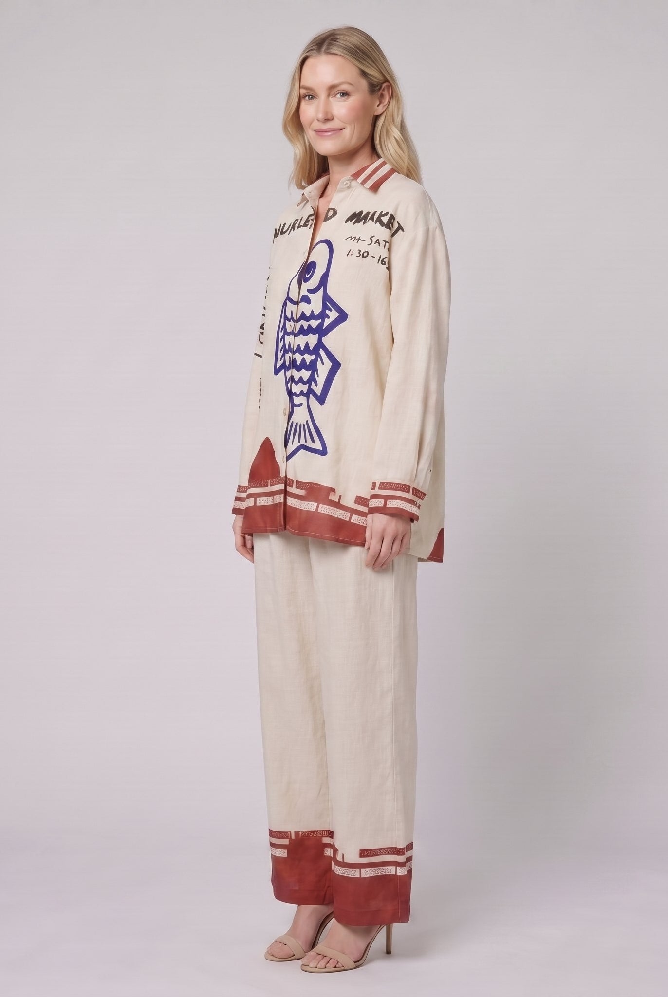 Rounelle cream linen set, three-quarter side view of shirt and wide-leg trousers