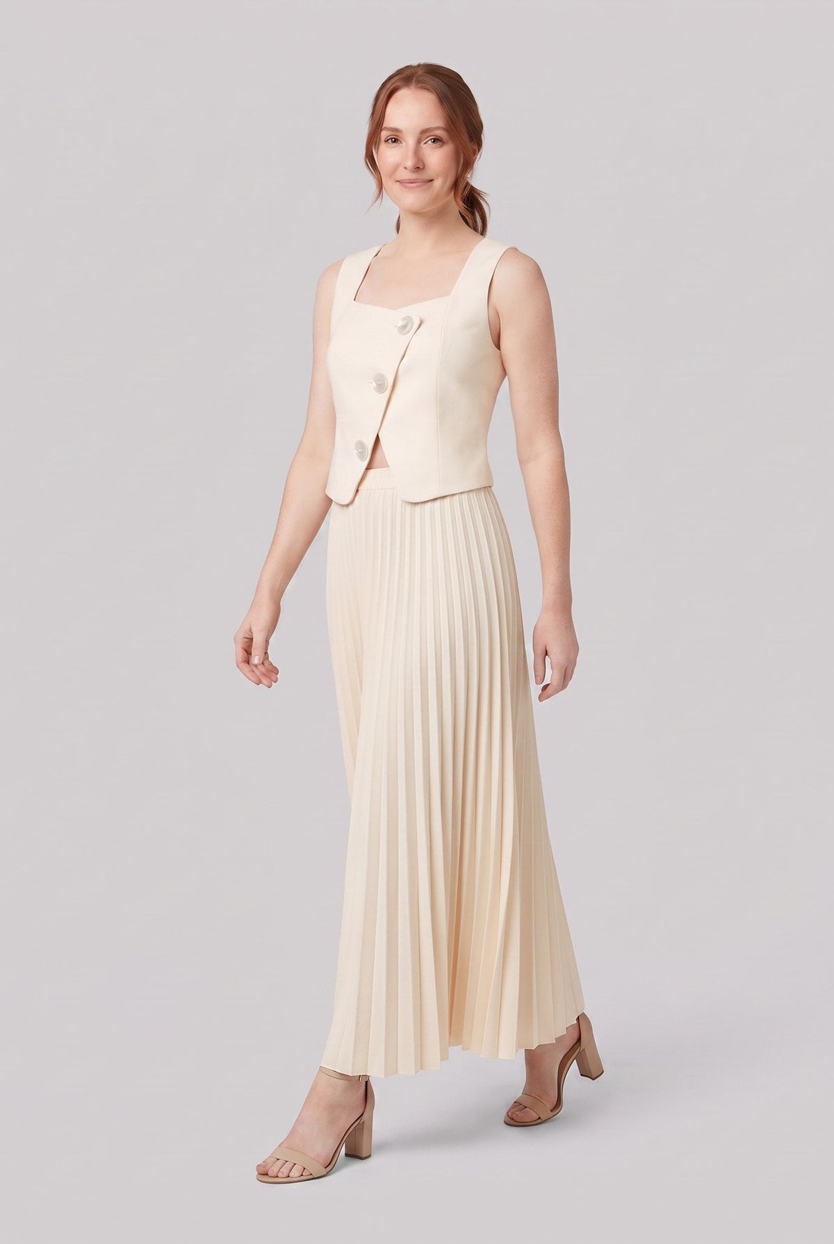 Sera Chic cream set, walking pose showing pleated maxi skirt