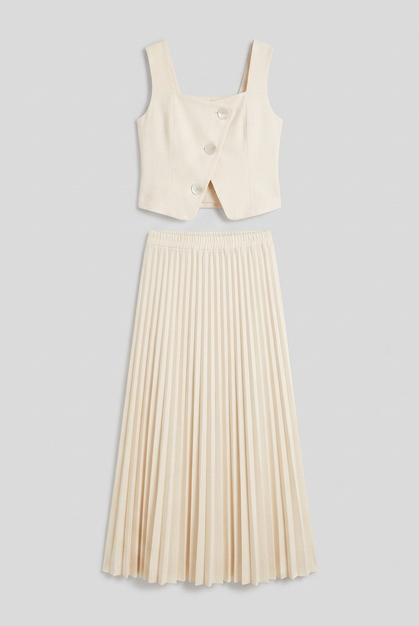 Sera Chic cream set flat lay, cropped waistcoat top and pleated maxi skirt